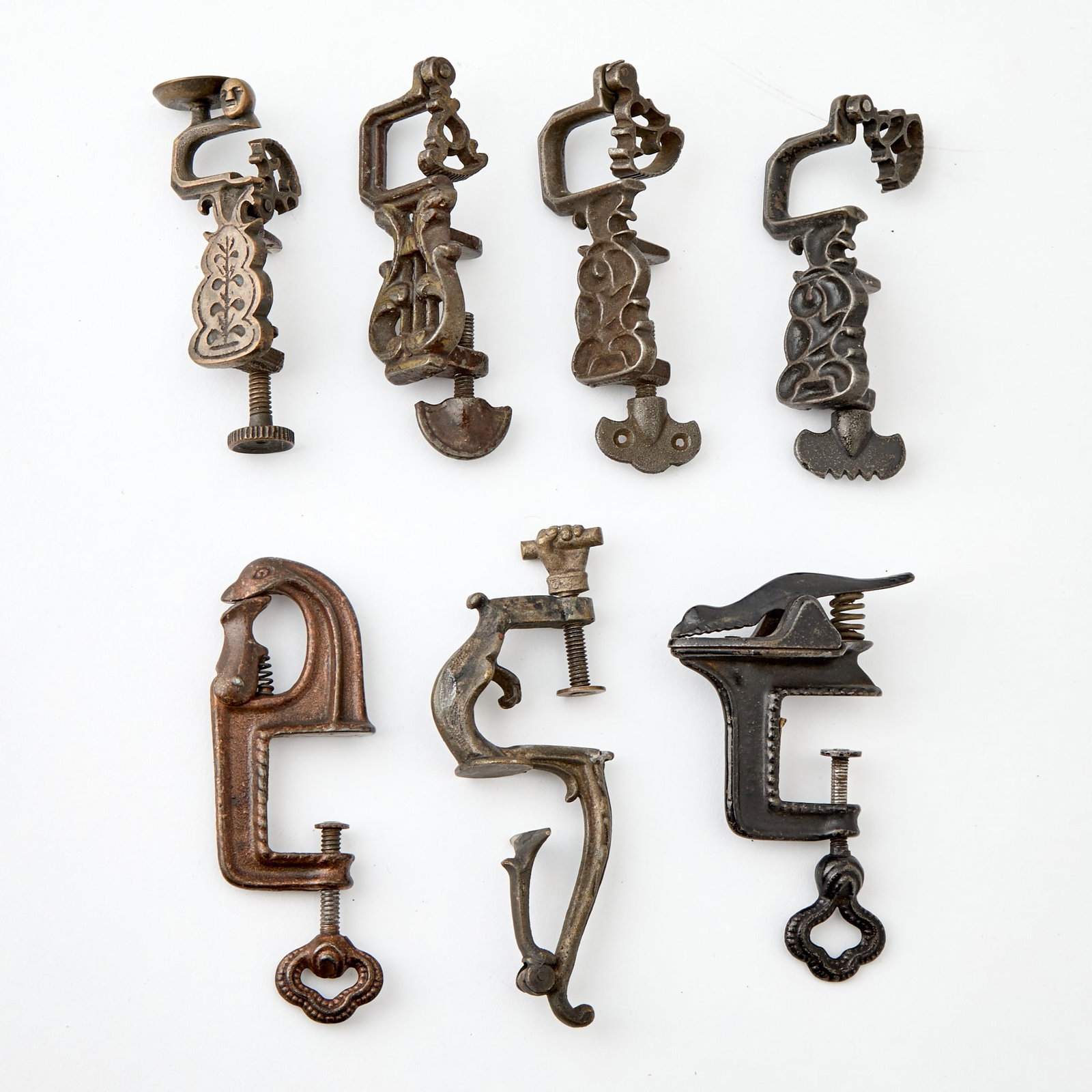 Seven Small Cast Iron Sewing or Quilt Clamps: Late 19th / early 20th century Some retaining original paint. Height of largest 5 inches.