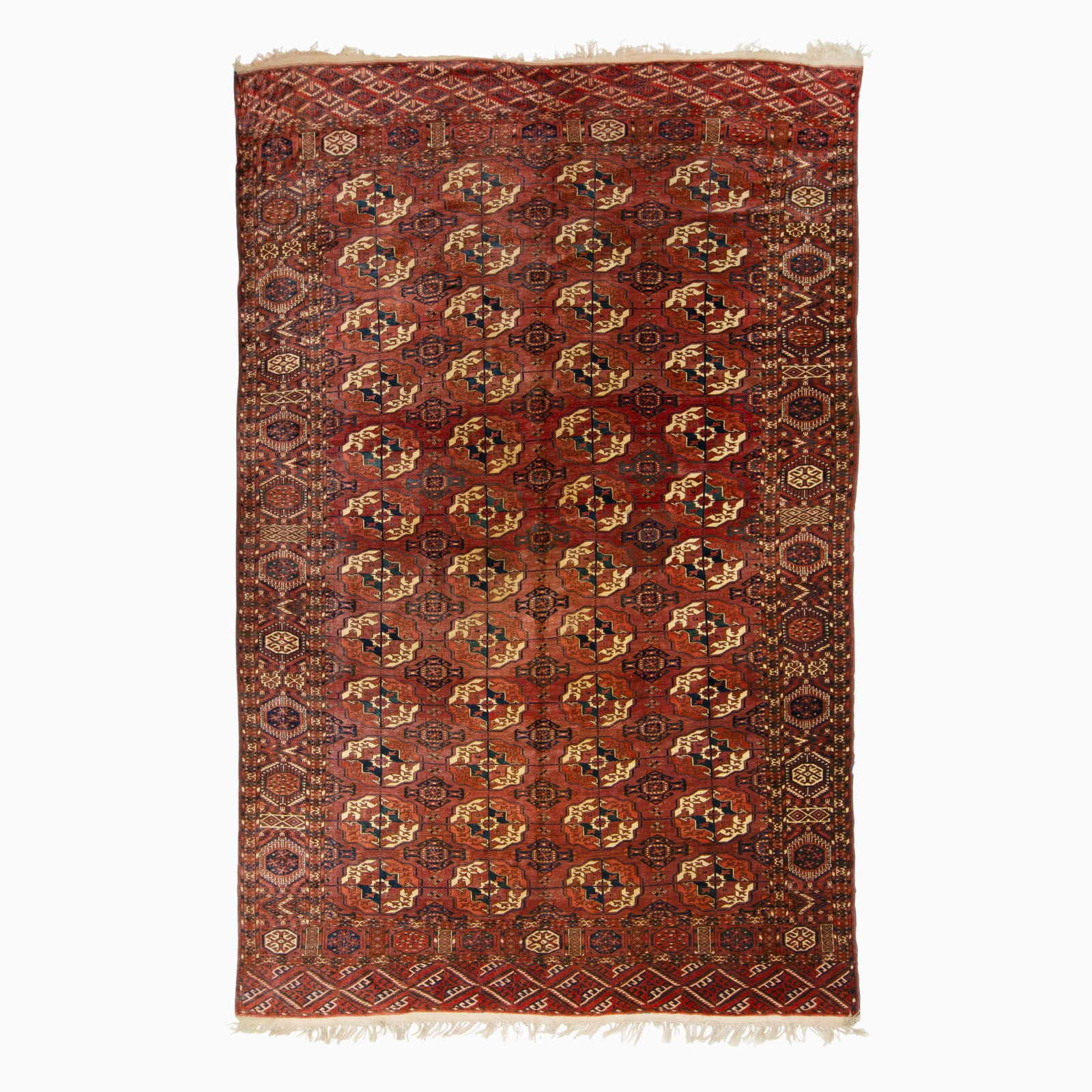 Tekke Carpet: East Iran, 2nd 1/4 20th Century Four columns of gul medallions on the madder field are within a stylized rosette border. (10' 2" x 6' 9")