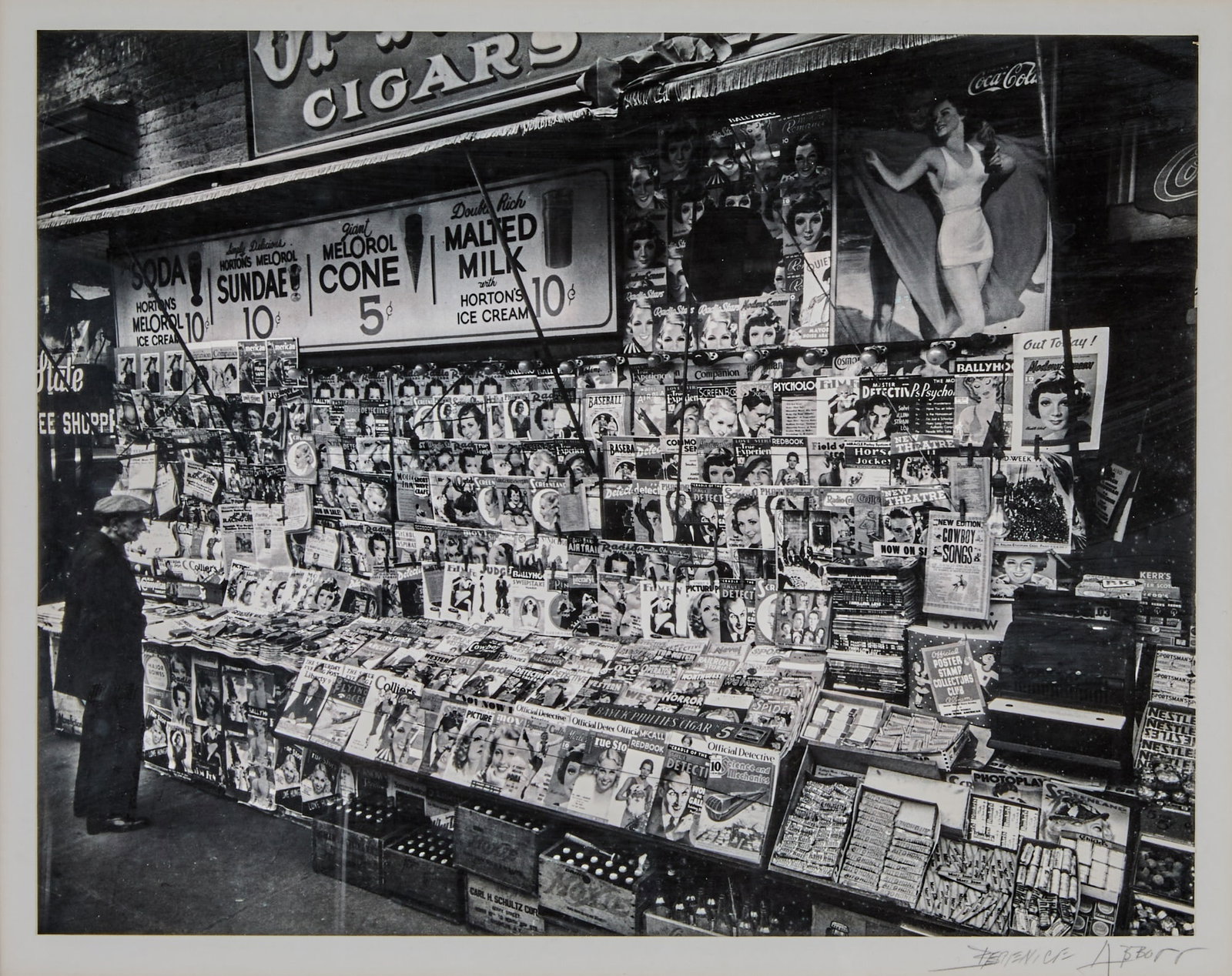 Berenice Abbott, Newsstand, 32nd Street and Third Avenue, Nov. 19, 1935: ABBOTT, BERENICE (1898-1991) Newsstand, 32nd Street and Third Avenue, Nov. 19, 1935, likely printed 1970s. Gelatin silver print, 10 3/4 x 13 3/4 inches (272 x 348 mm), dry-mounted, signed in pencil on