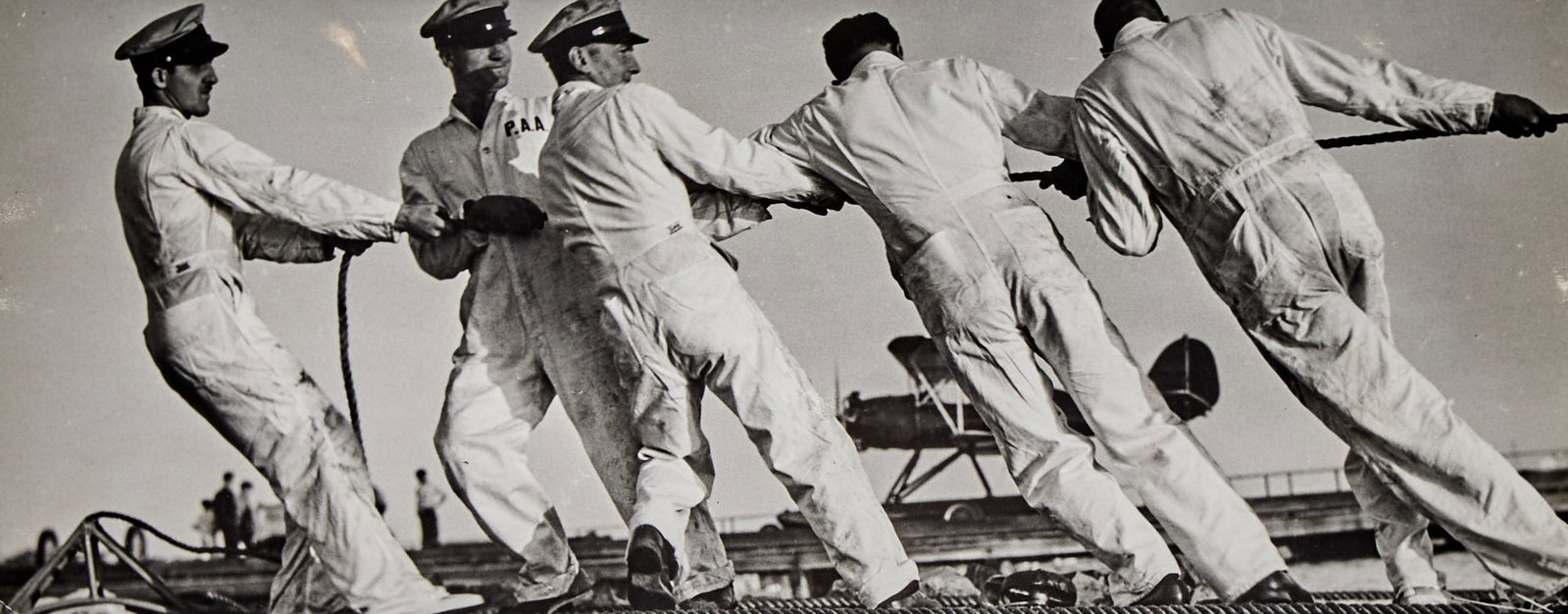 BOURKE-WHITE, MARGARET: BOURKE-WHITE, MARGARET (1904-1971) Ground crew pulling ropes attached to the British Imperial Airways seaplane, Port Washington, NY., 1937, likely vintage. Gelatin silver print, 5 5
