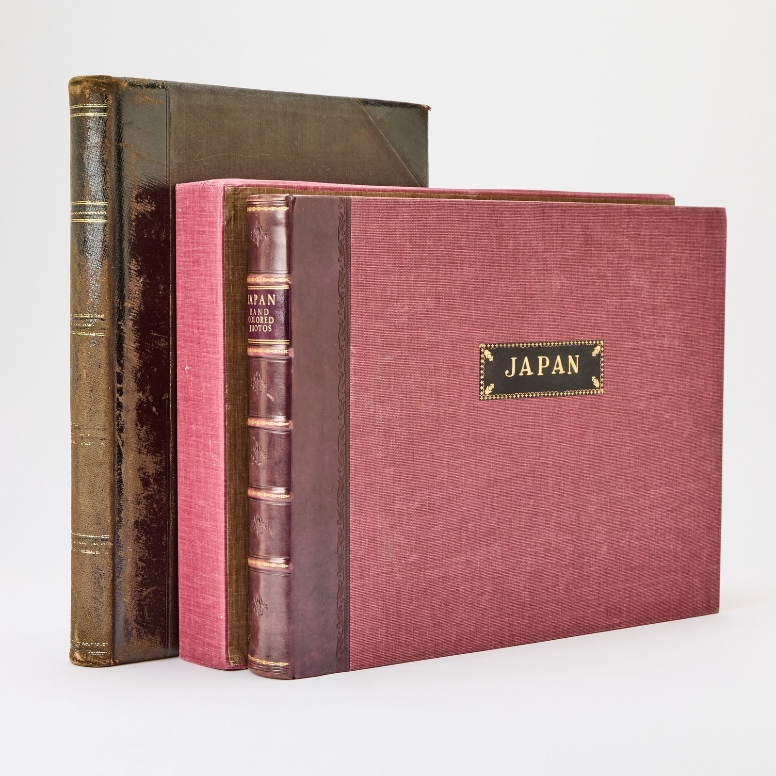 Two fine albums of Japanese views: [JAPANESE PHOTOGRAPHY] Two albums of commercially produced hand-colored photographs of Japan. Likely Tokyo: 1890s. One volume 19th-century leather, marbled sides, the other modern leather-backed cloth