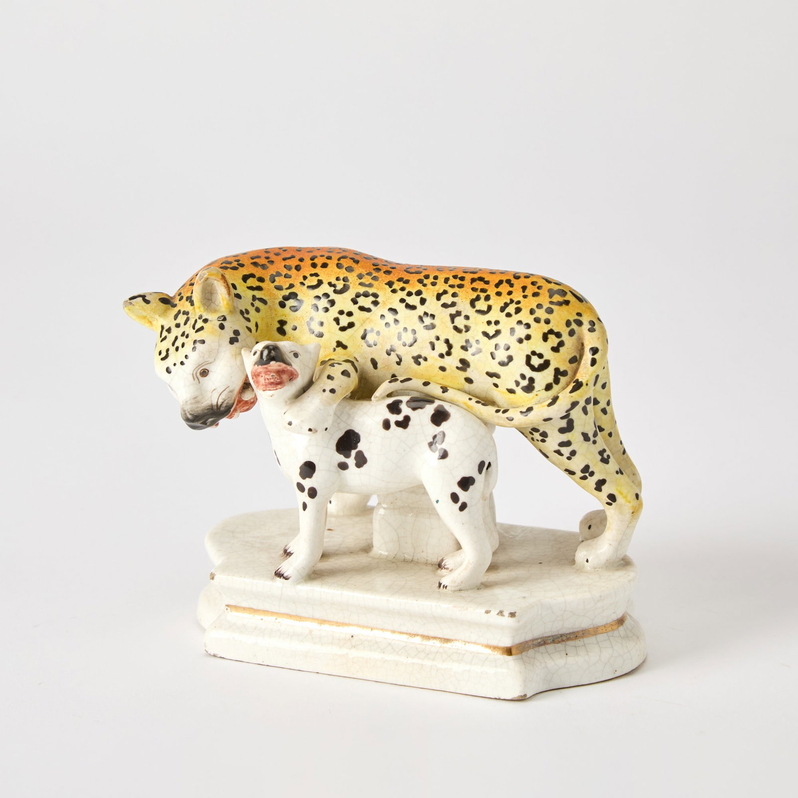 Staffordshire Group of a Leopard and Cub: Mid-19th Century Modeled on a shaped rectangular base. Height 3 3/4 inches. Provenance: Oliver Sutton Antiques