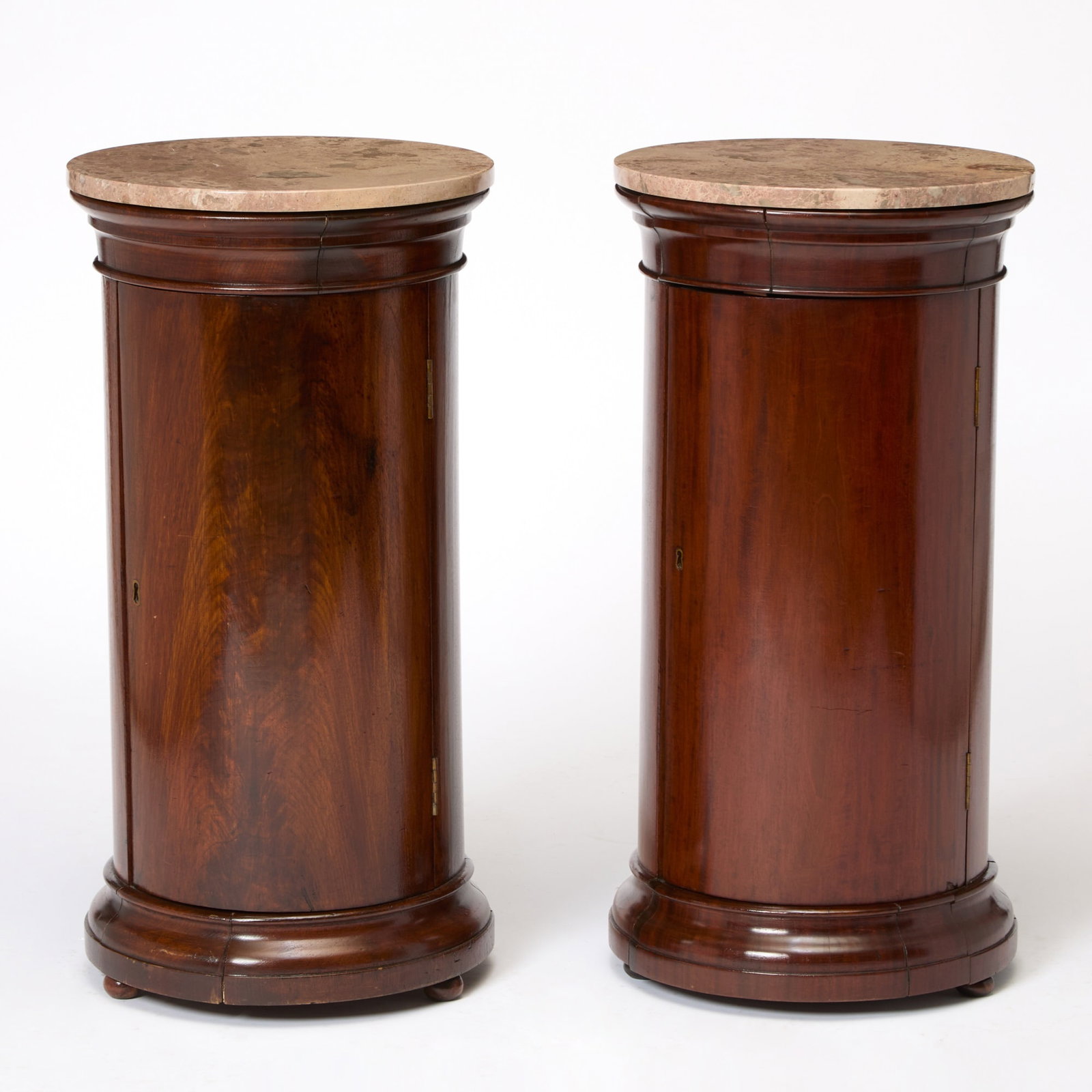 Pair of Marble Top Mahogany Columnar Cabinets: Height 31 1/2 inches, diameter 16 inches.