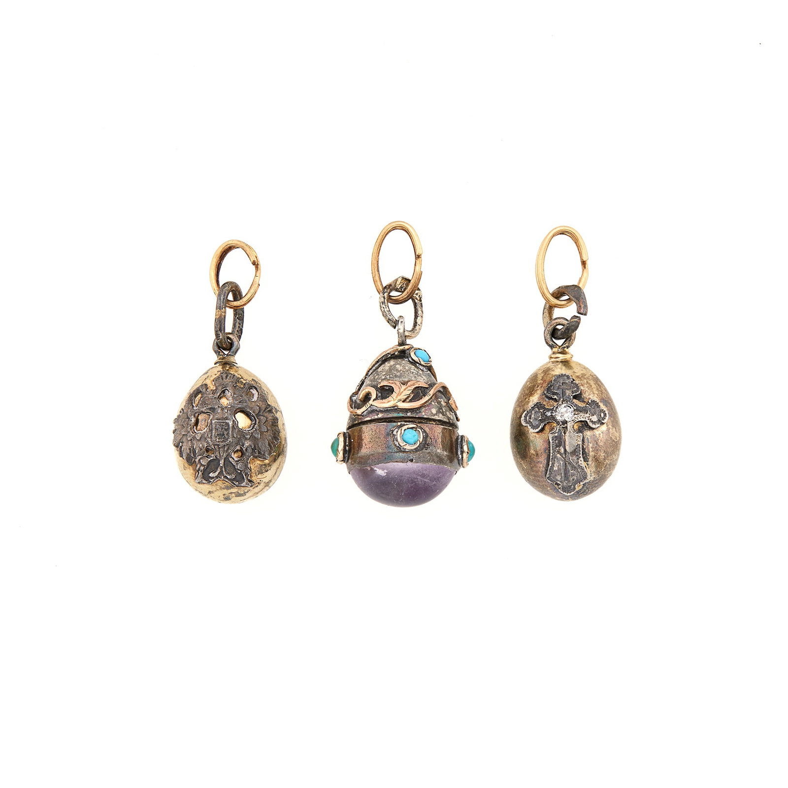 Group of Three Russian and Russian Style Silver Pendant Eggs: Late 19th-20th century Height of largest 3/4 inch, including suspension loop.