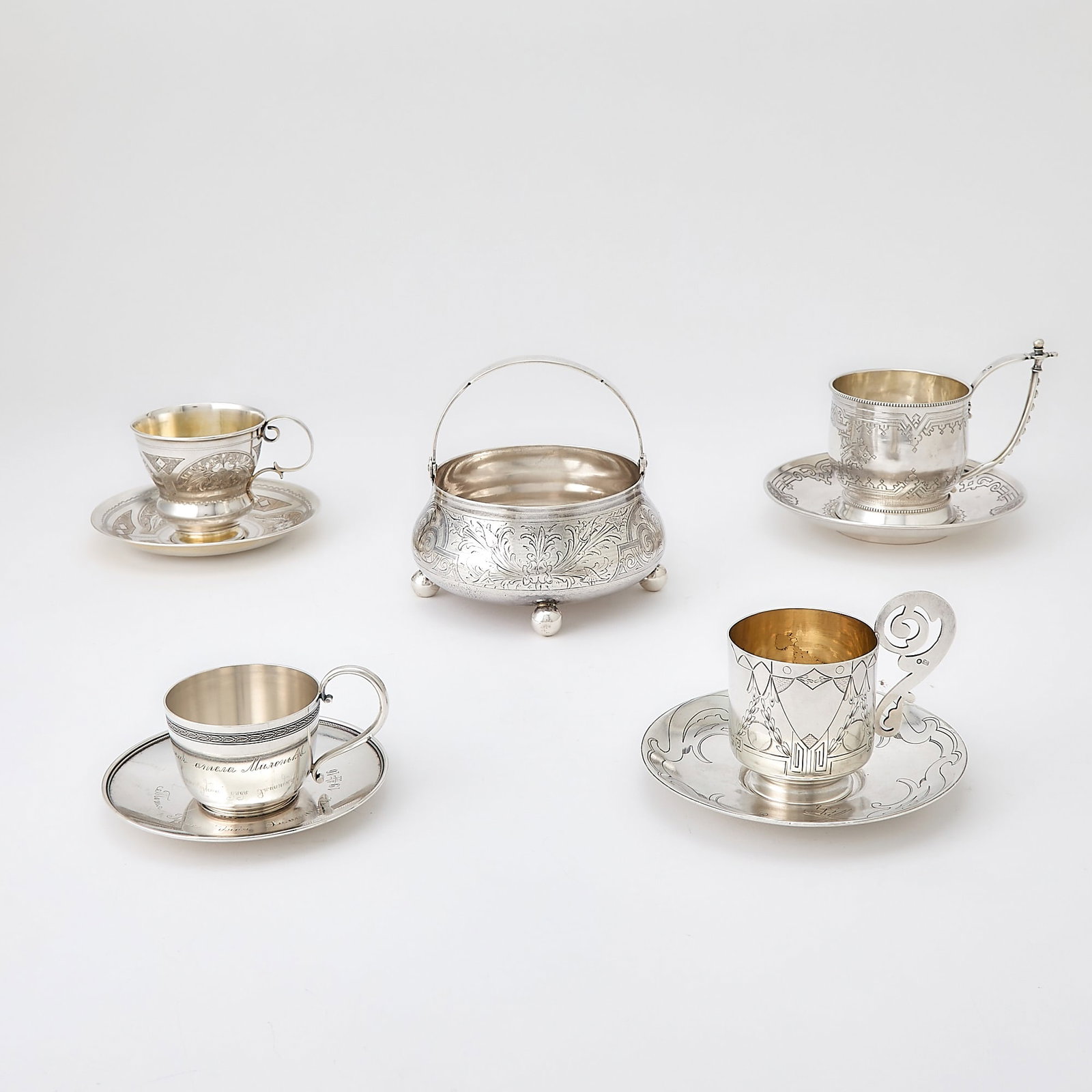 Group of Russian Silver Articles: Late 19th-early 20th century Comprising a sugar bowl, four cups and saucers. Diameter of sugar bowl 4 5/8 inches, total approximately 27.5 ounces.