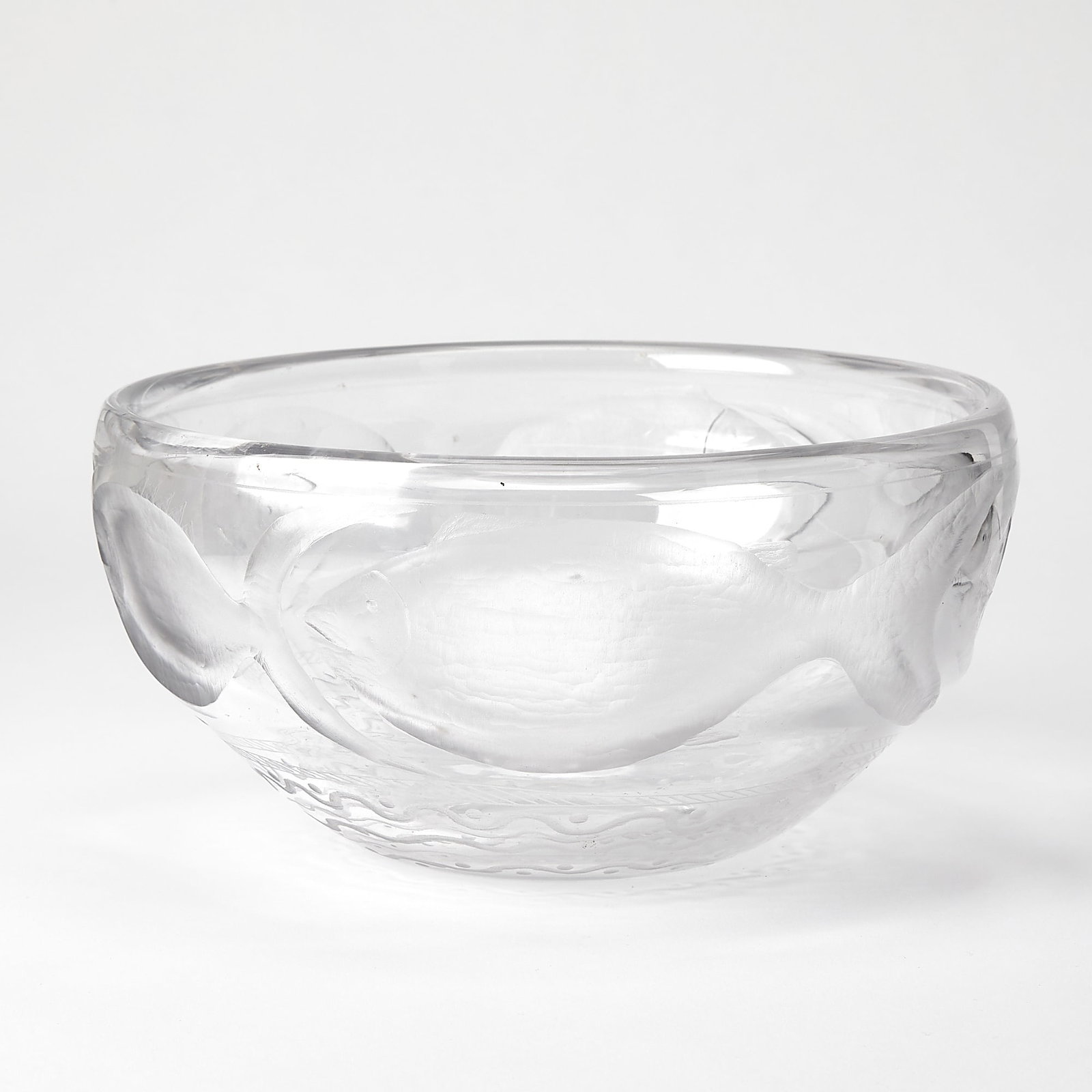 Kosta Boda Blown and Engraved Glass Bowl: Designed by Erik Hoglund In colorless glass, carved with a band of five trigger fish, inscribed Boda H865/1200. Height 5 1/2 inches, diameter 10 1/2 inches.
