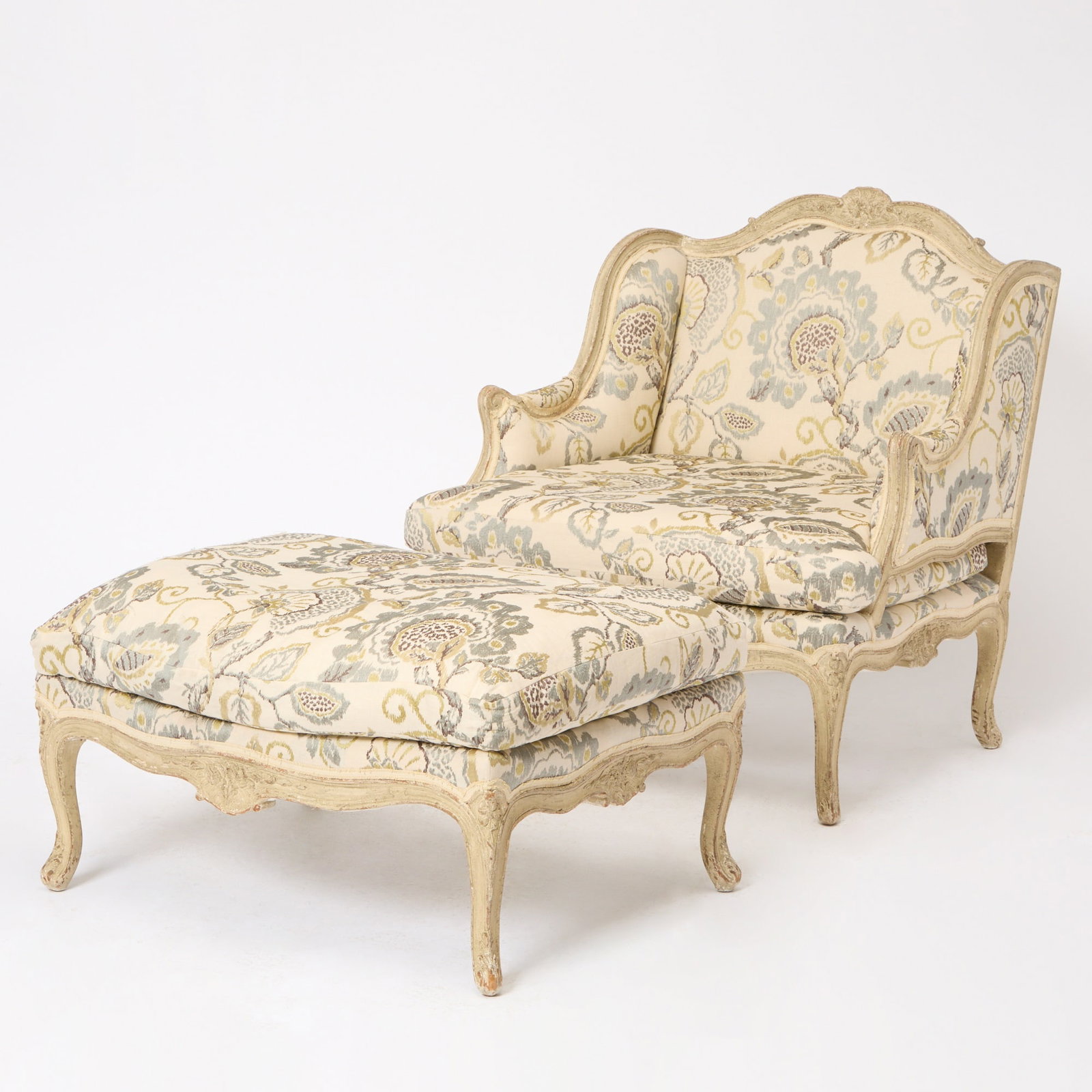 Louis XV Style Painted Upholstered Marquise Chair and Ottoman: Height of chair 38 1/2 inches, width 35 inches, depth of seat 27 inches; height of ottoman 17 inches, width 34 1/2 inches.