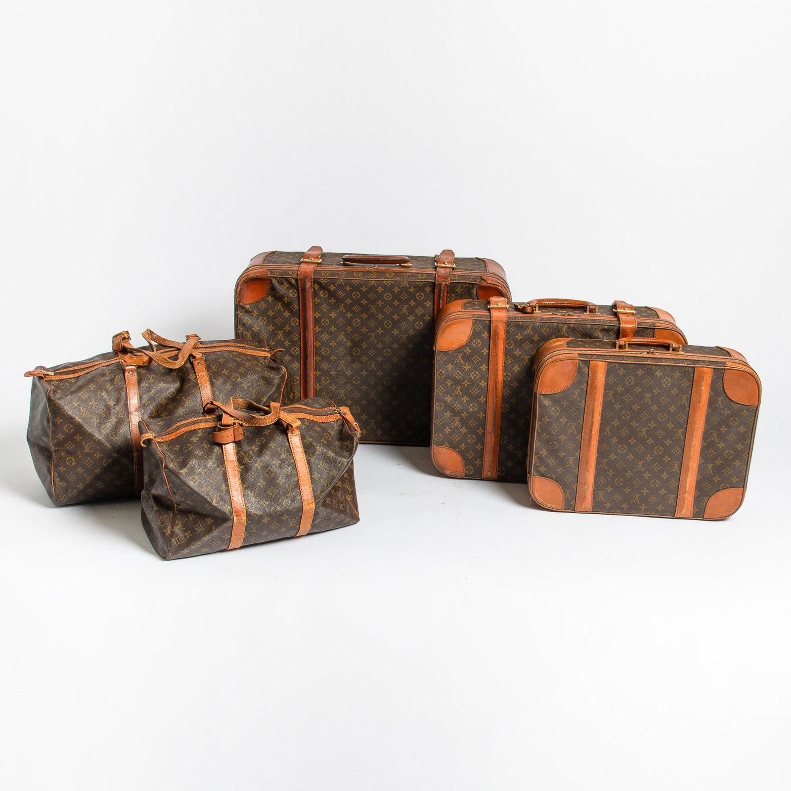 Group of Five Louis Vuitton Soft Suitcases and Satchels: Also includes five luggage tags and four keys.