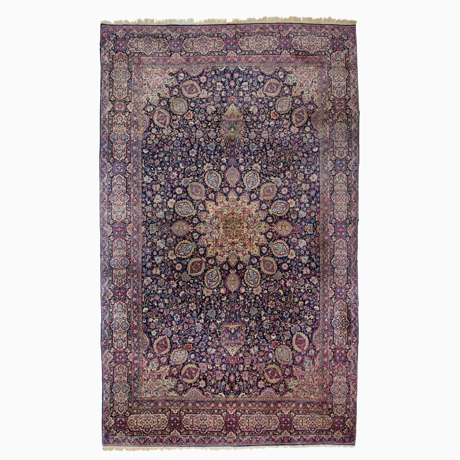 Kerman carpet: Southeast Iran, Mid-20th Century Of Ardebil-design with a central circular pendant medallion flanked by complementary spandrels on the midnight blue field within a rosette and cartouche border. 224