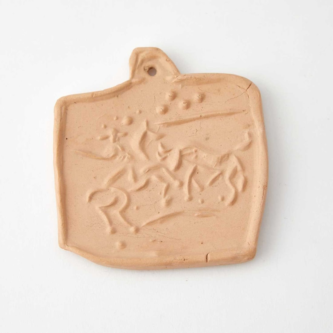 Pablo Picasso (1881-1973): PICADOR ET TAUREAU (ALAIN RAMIÉ 101) Red ceramic medallion, 1950, from the edition of 100, with Empreinte Originale de Picasso pottery stamp on the reverse. 3 1/2 x 3 1/4 inches; 8.8 x 8.2 cm