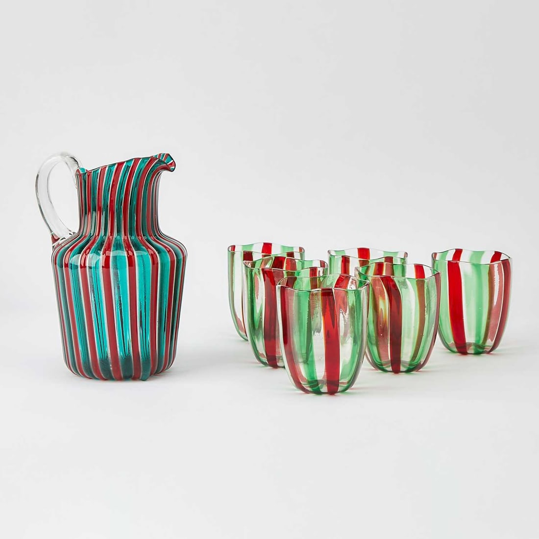 Gio Ponti for Venini Murano Hand-Blown Glass " a Canne" Pitcher: Model no. 909, second half 20th century The cylindrical body formed of alternating vertically arranged transparent red and green canes on a colorless glass base, with an applied colorless glass