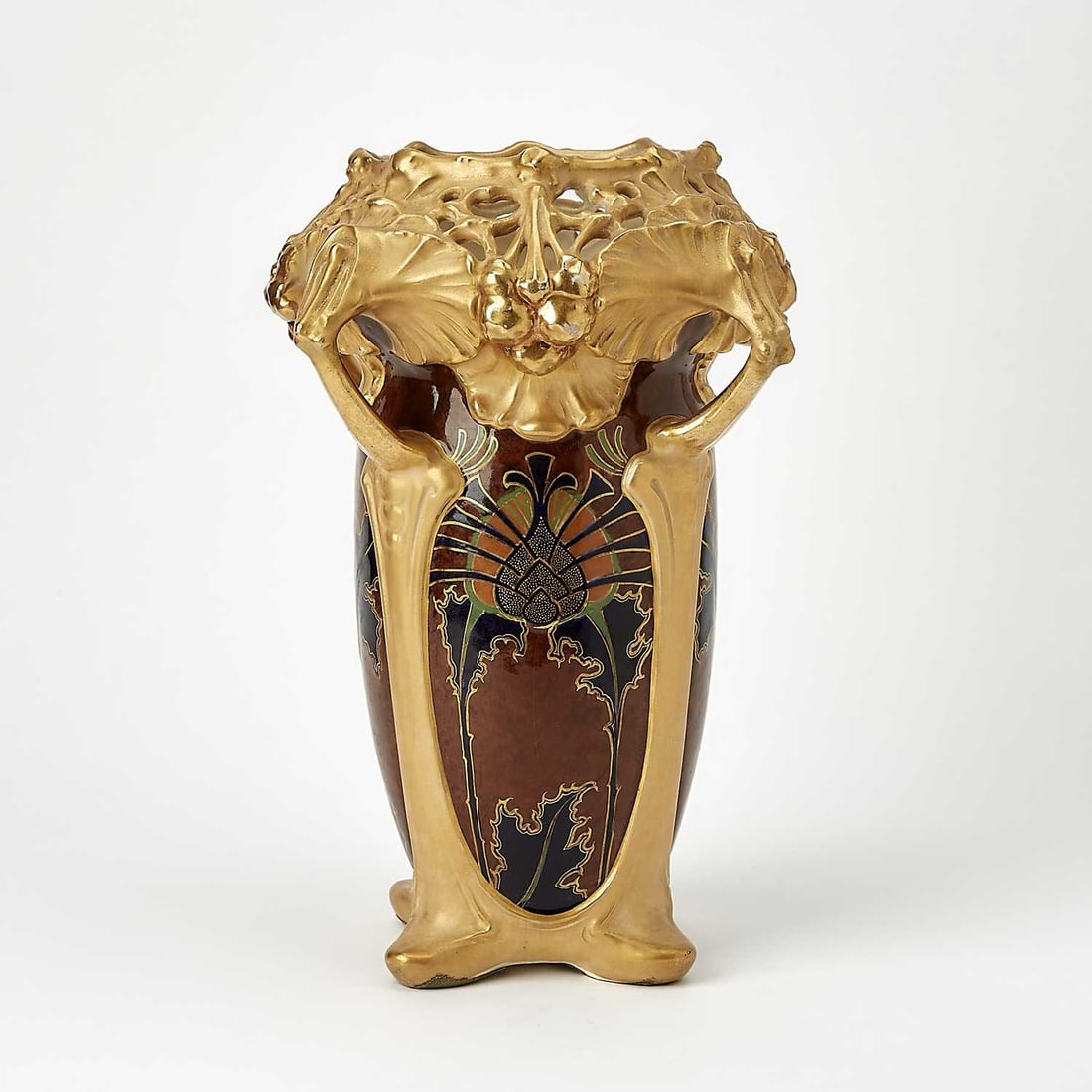 Ernst Wahliss Art Nouveau Gilt and Hand-Painted Earthenware Vase: Circa 1900 Of flower form, with a pierced blossom-form mouth, four stem-form protruding handles, and a glazed ovoid body, red stamp mark on the underside. Height 13 1/4 inches, width 10 3/4 inches.