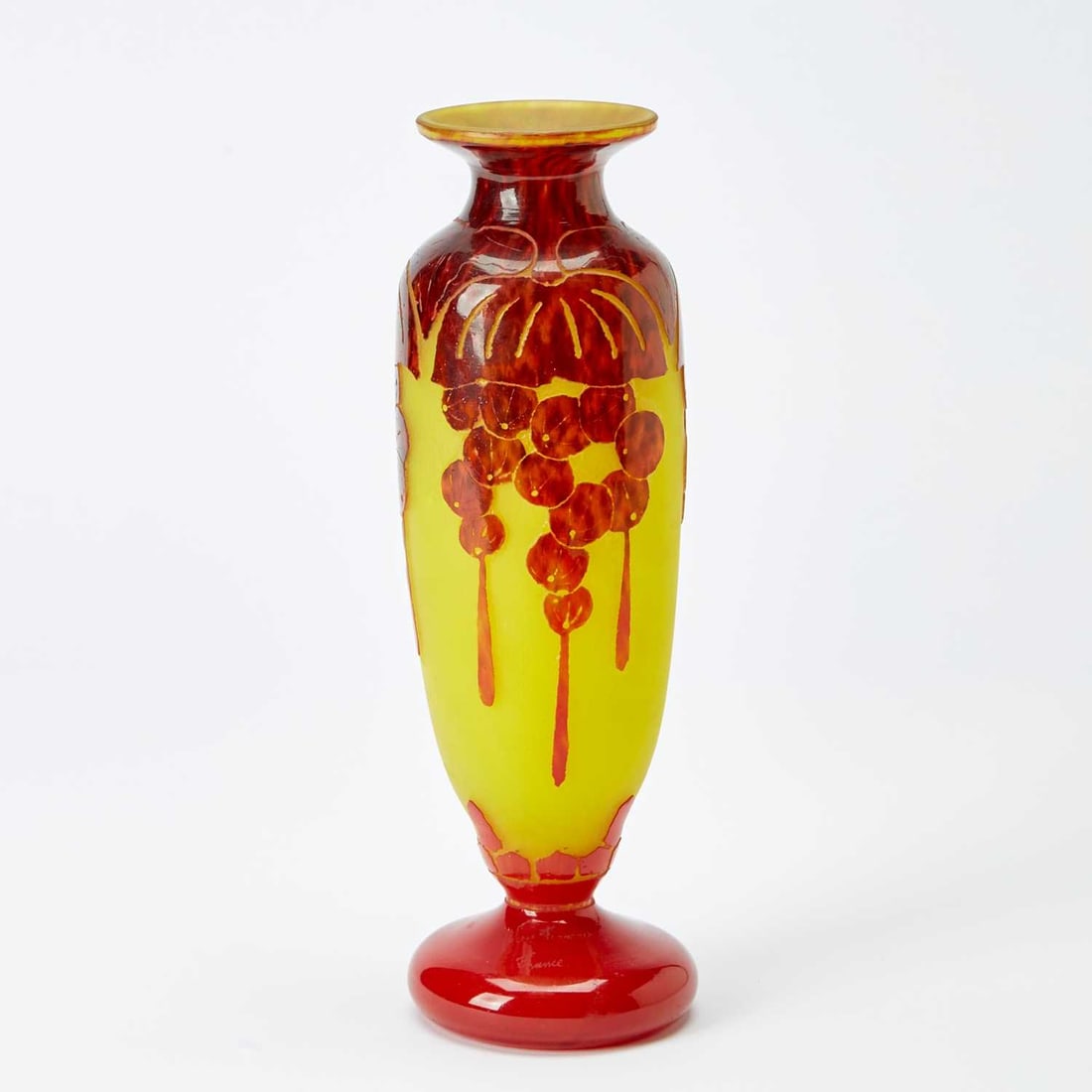 Le Verre Francais Art Deco Acid-Etched Cameo Glass Vase: Retailed by Ovington Bros., New York, circa 1923-26 In the Groseilles (Red Currants) pattern, of elongated baluster form, in mottled plum colored glass cased over opaque yellow glass, decorated with g