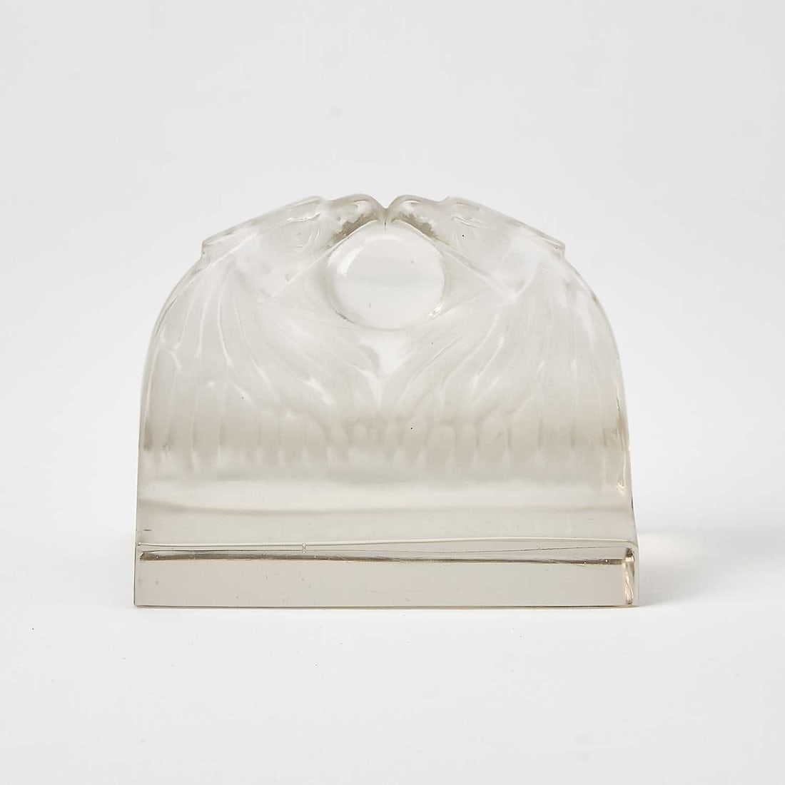 R. Lalique Molded Glass "Deux Aigles" Paperweight: Marcilhac no. 801, circa 1914-47 Modeled as a two confronting eagle heads with an orb in their open beaks, in colorless glass, satin and glossy finish, intaglio molded signature R. LALIQUE. Height 3 1