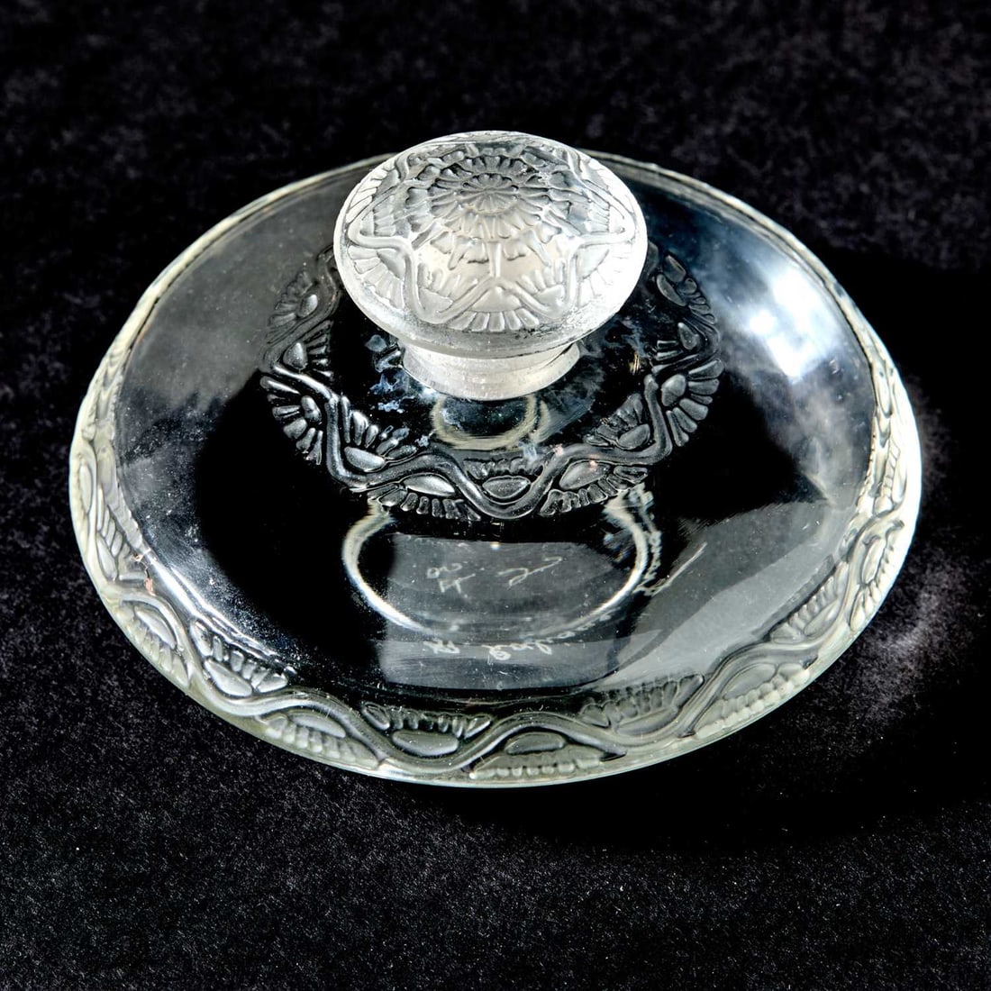 R. Lalique Molded Glass "Lentilles" Perfume Bottle and Stopper: Model introduced 1912 Of compressed form, in colorless glass, engraved on the underside R. Lalique France No. 485. Height 2 inches.