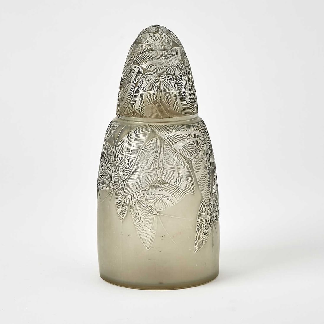 R. Lalique Molded Opalescent Glass "Papillons" Brûle-Parfums: Marcilhac no. 2650, circa 1920-47 Of bottle form with a loose domed cover, molded allover with butterflies, heightened with blue-gray patina, molded R. LALIQUE. Height 7 3/8 inches.