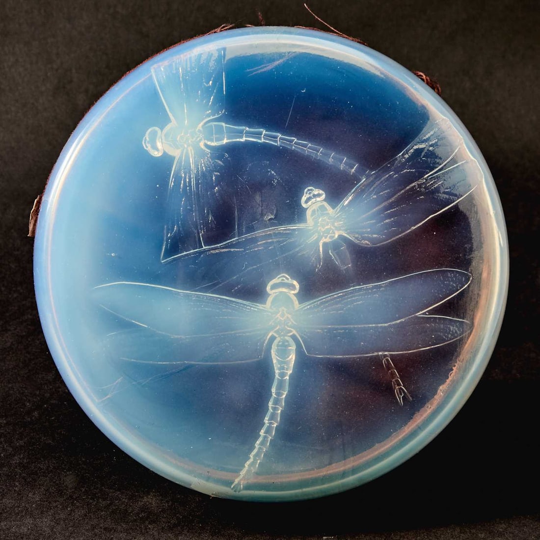 R. Lalique Molded Opalescent Glass "Georgette" Lidded Box: Also known as "Trois Libellules," Marcilhac no. 45, circa 1922-47 Of circular form, the glass cover molded on the interior side with three large dragonflies in flight with overlapping wings, in relief