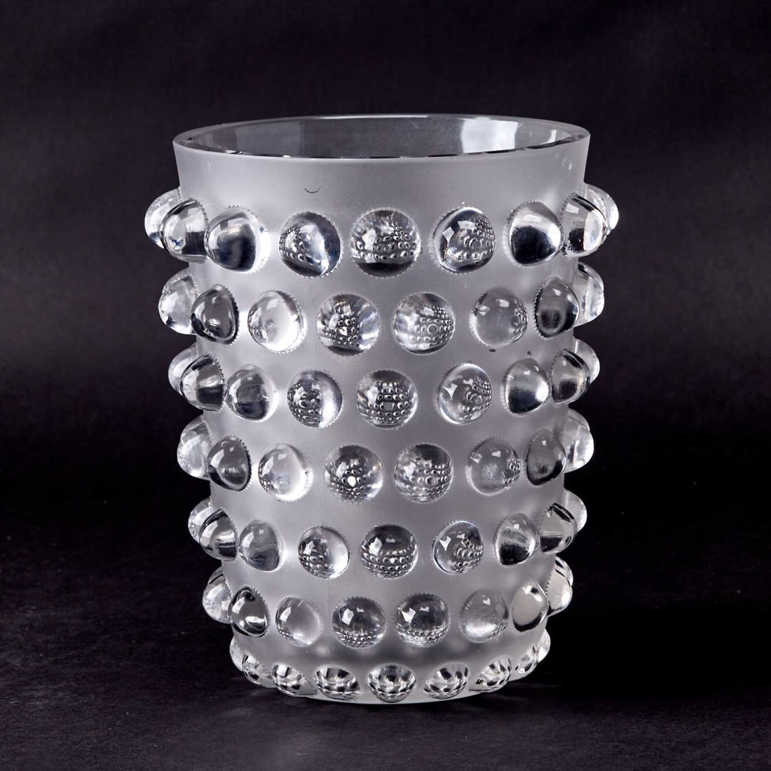 R. Lalique Molded Glass "Mossi" Vase: Marcilhac no. 1088, designed 1933, this example second quarter 20th century Of tapering circular form, in colorless glass, with seven graduated rows of protruding boses, satin and glossy finish, acid-
