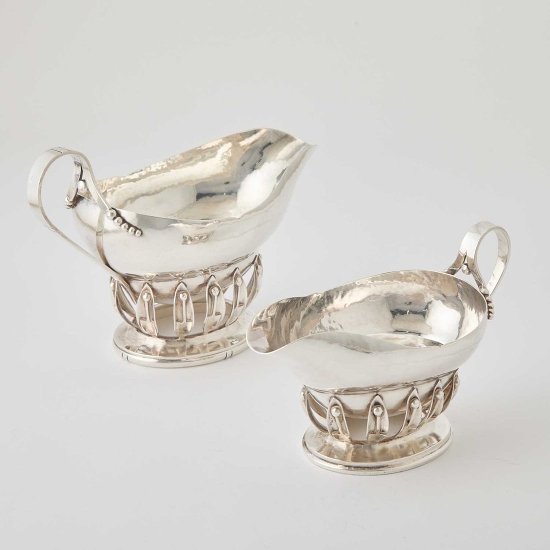Two Mexican Sterling Silver Sauceboats: William de Matteo, mid 20th century Height of larger 6 inches, length 9 inches. Together with Four Sterling Silver Sauce Ladles. Total approximately 36 ounces.
