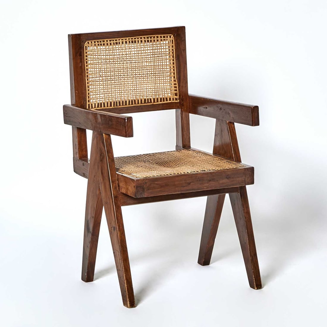 Pierre Jeanneret Teak and Cane "Model PJ-SI-28-A" Floating Back Office Chair: Mid 20th century Height of back 35 1/2 inches, height of seat 17 1/2 width 20 inches, depth 21 1/4 inches. Provenance: Gallery 1950/Alberto Aquilino, New York