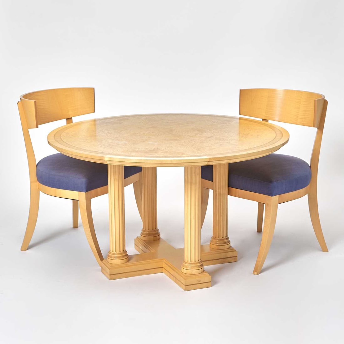 David Linley Burlwood Center Table and Pair of Upholstered Sycamore Side Chairs: Late 20th century Height of table 29 3/4 inches, diameter 47 inches; height of back of 32 3/4 chairs inches, height of seat 19 inches, width 22 inches, depth 22 inches.