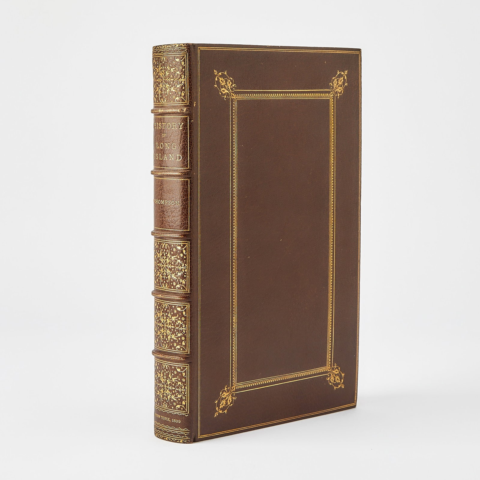A finely bound copy of Thompson's History of Long Island: THOMPSON, BENJAMIN F. History of Long Island. New York: E. French, 1839. First edition. Bound by Bradstreet's in full brown morocco gilt, raised bands, elaborate gilt dentelles, top edge gilt, marbled
