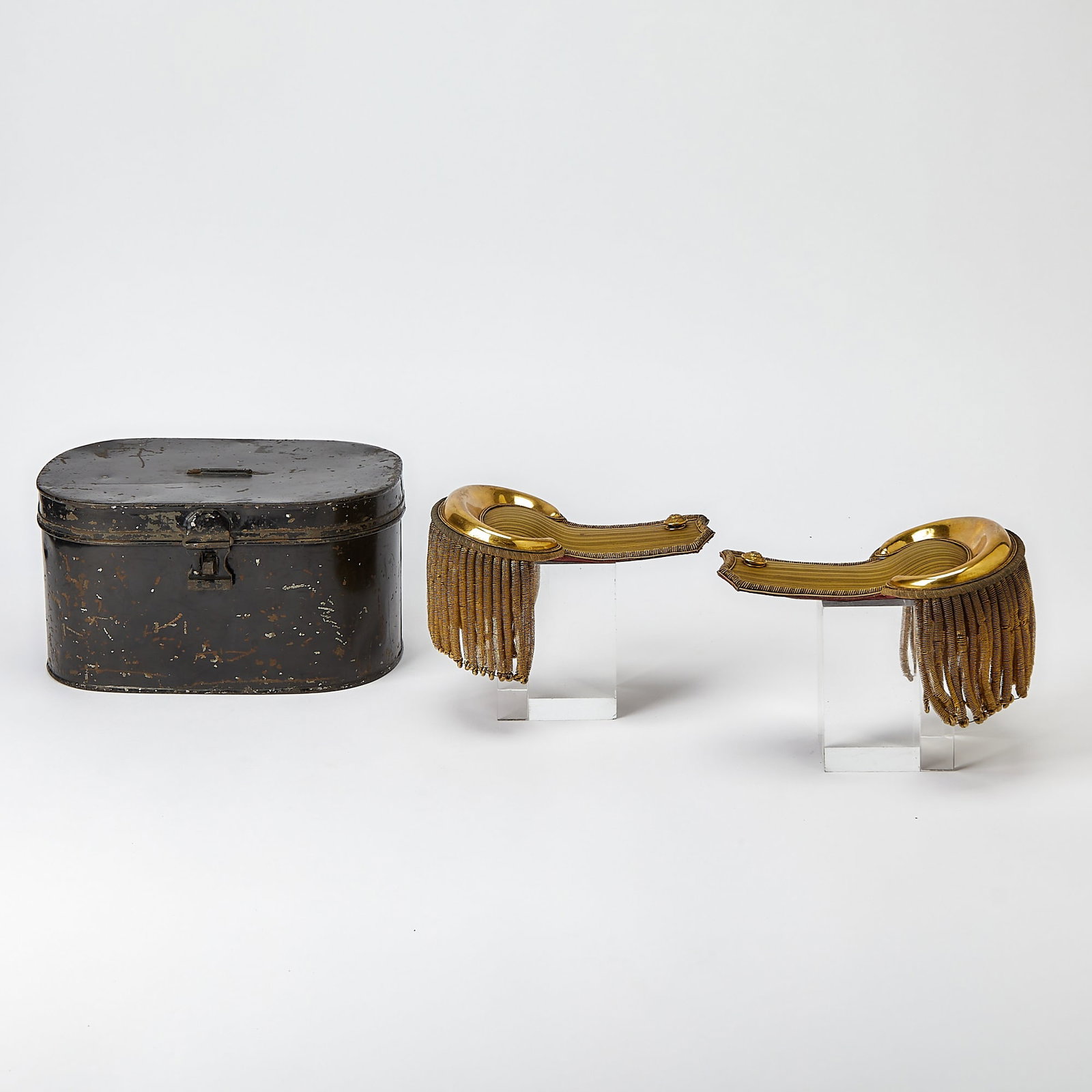 A pair of antique military epaulets: [ENGLISH MILITARY] London: Circa 1860s. A pair of gold-plated military epaulets. Both stamped on the underside with the maker "Nicholls & Sons / Jermyn St[reet] / London." Housed in the original
