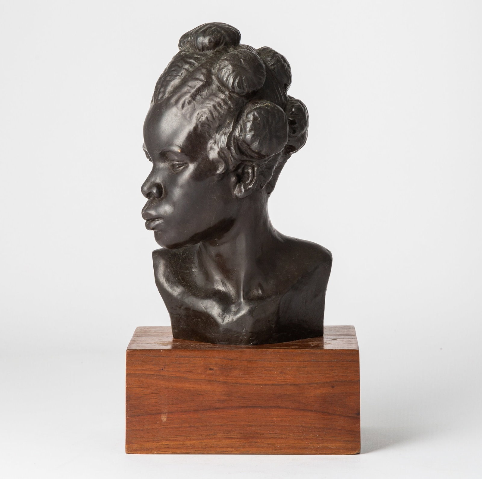 Malvina Cornell Hoffman: American, 1887-1966 Martinique Woman Numbered, inscribed and dated indistinctly E. 10/12 Martinique/ 19...1 on the back Bronze, on a wood base Height of bronze 8 inches (20.3 cm)