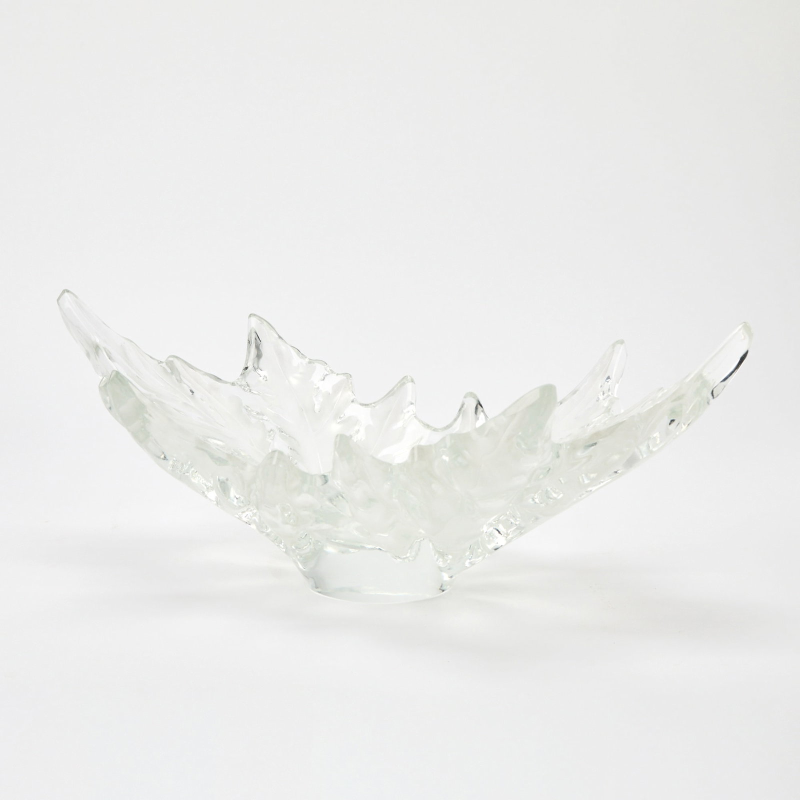 Lalique Molded Glass Champs-Elysees Bowl: Late20th/early 21st century Of shallow form, modeled as two opposed stylized maple leaves, in colorless glass, satin and glossy finish, engraved Lalique France. Height 7 1/4 inches, width 18 inches.