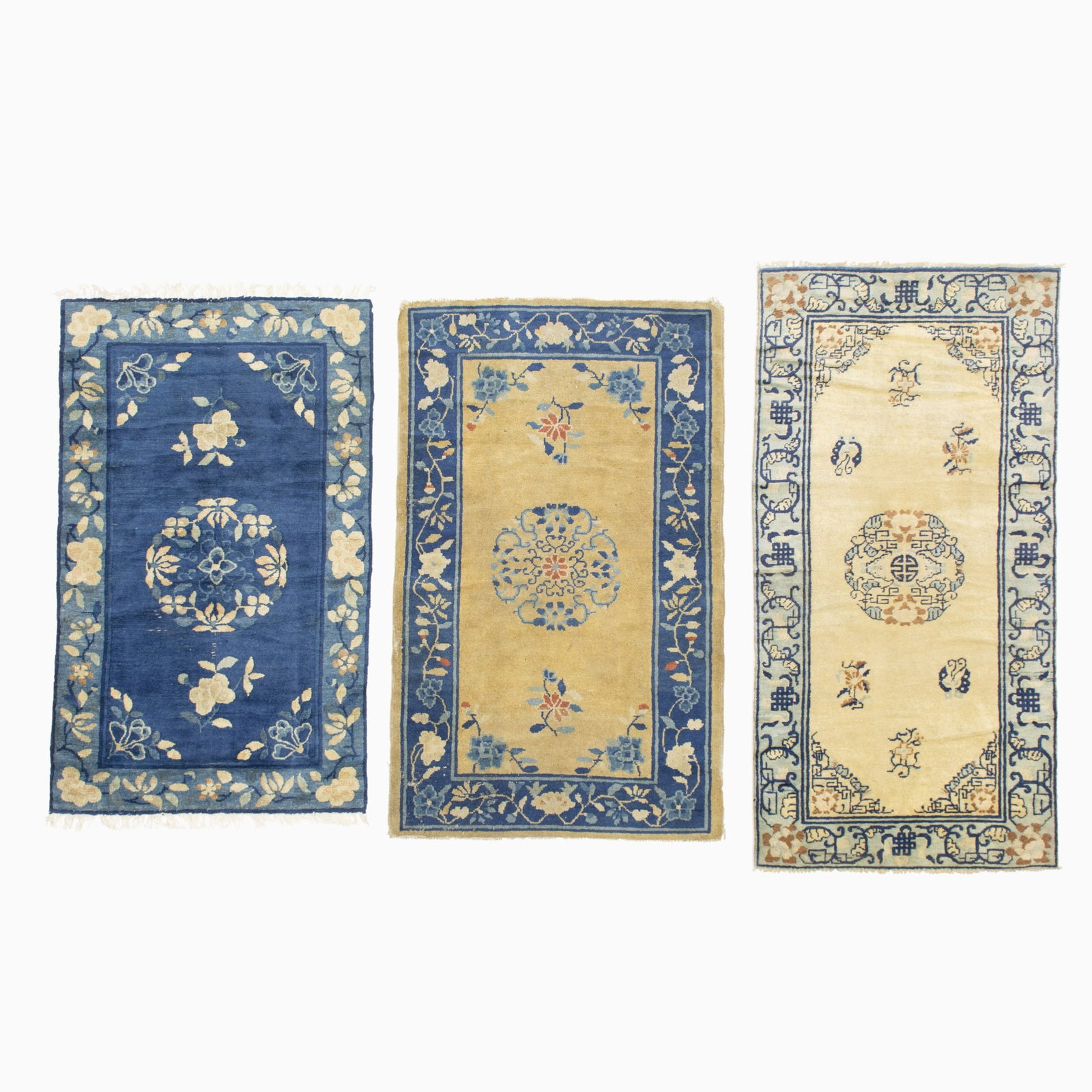 Three Peking Chinese Rugs: China, Early 20th Century Each with a central circular medallion within floral vinery borders. (5' 7" x 2' 10" , 4' 10" x 3' 0" , and 4' 8" x 2' 10") Ivory field - even wear, reselvedged Camel field