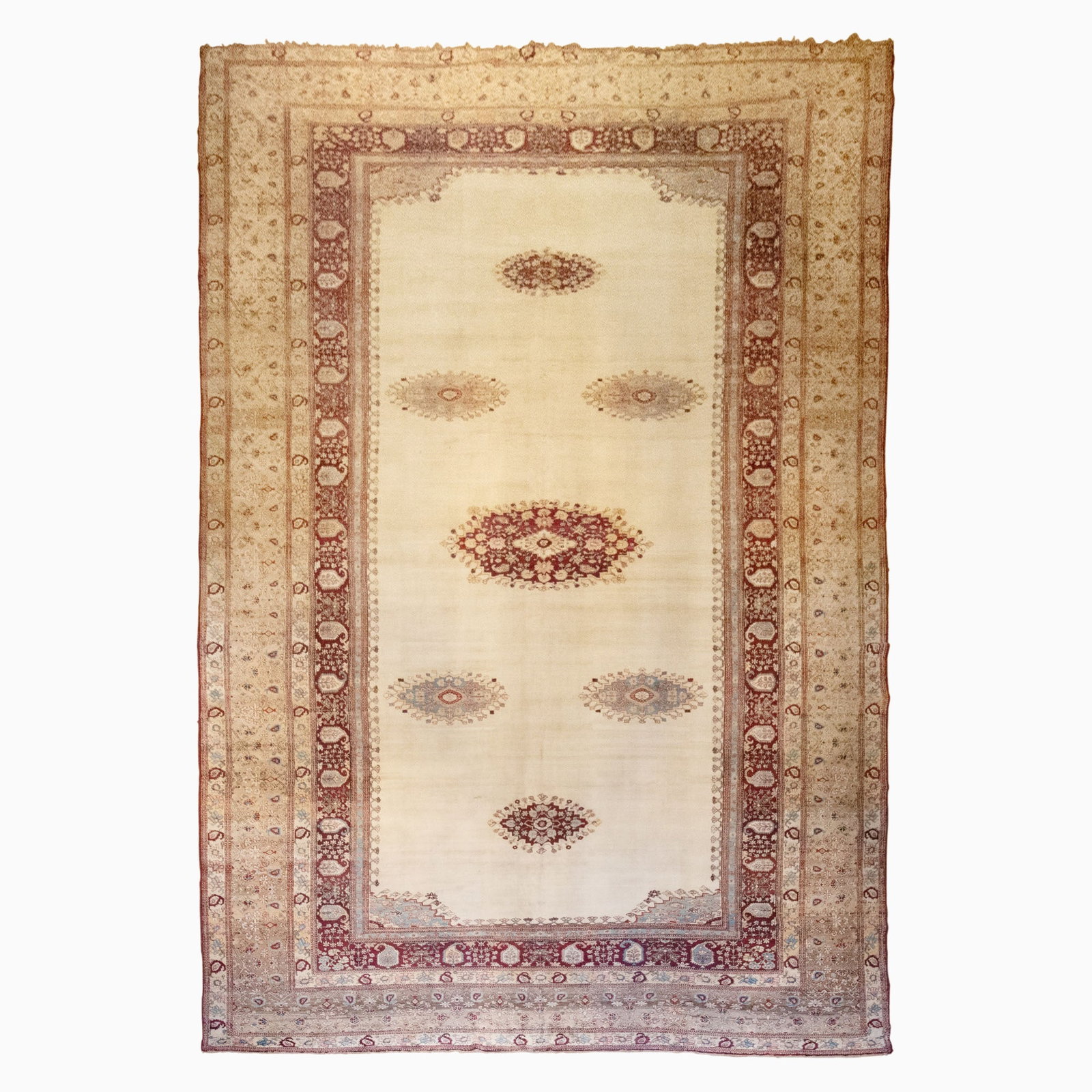 Agra Carpet: North India, Late 19th Century Seven polychrome oval medallions on the open ivory field are within a buff floral vinery border. 24 feet 0 inches x 13 feet 7 inches. (24' 0" x 13' 7") Small breaks to