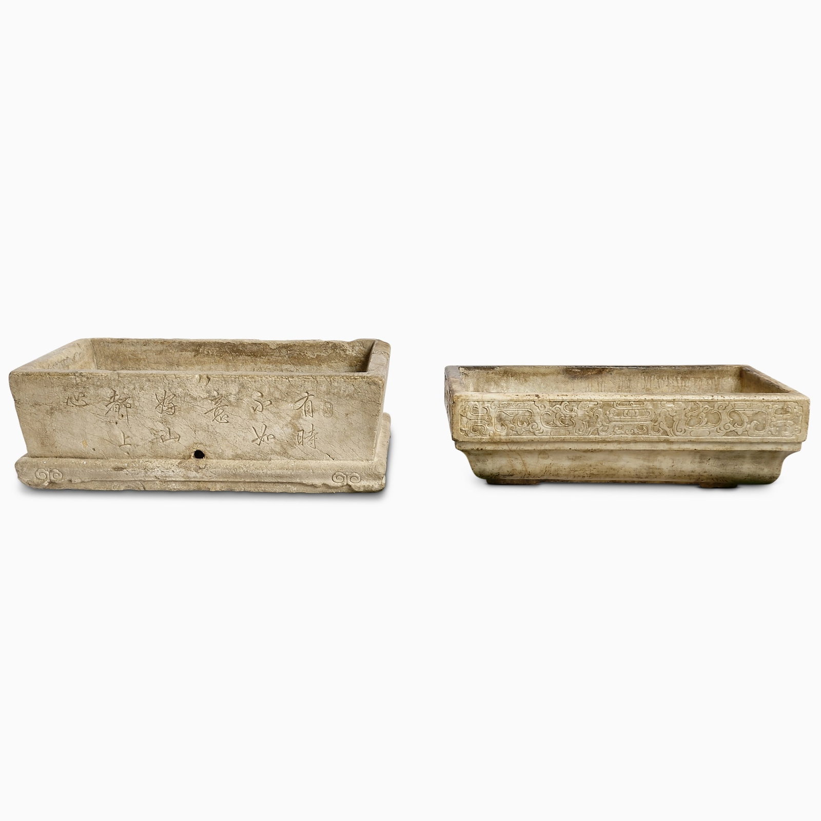 Pair of Chinese Stone Basins Qing Dynasty and Earlier: Each of rectangular form; carved with verses in Chinese and stylized archaistic bands, respectively. (Larger 31 3/4 X 19 inches)
