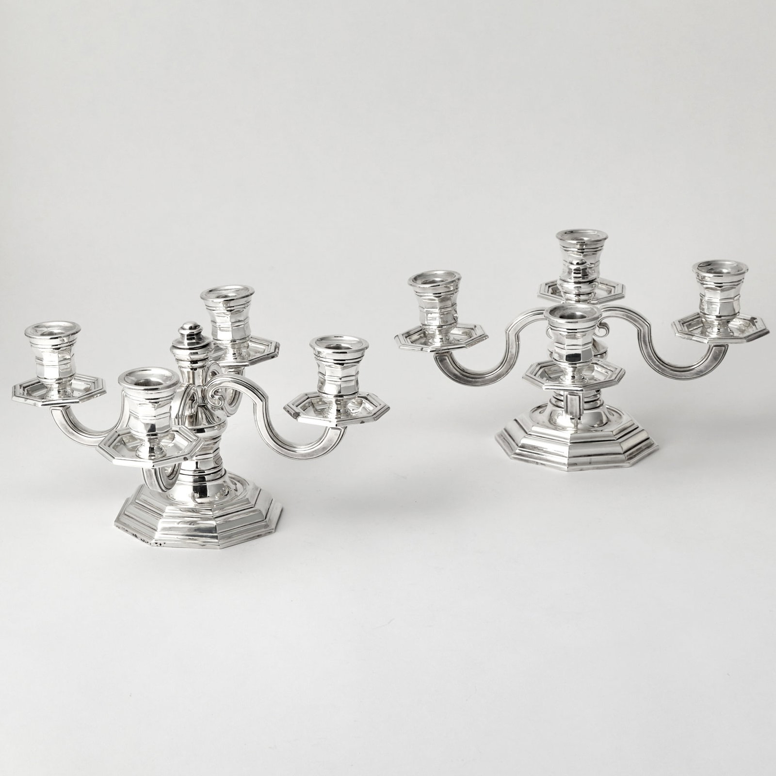 Pair of Christofle Silver Plated Four-Light Low Candelabra: 20th Century Each with four scrolling branches centering a central knop, on an octagonal base. Height 6 3/4 inches, diameter 13 inches.