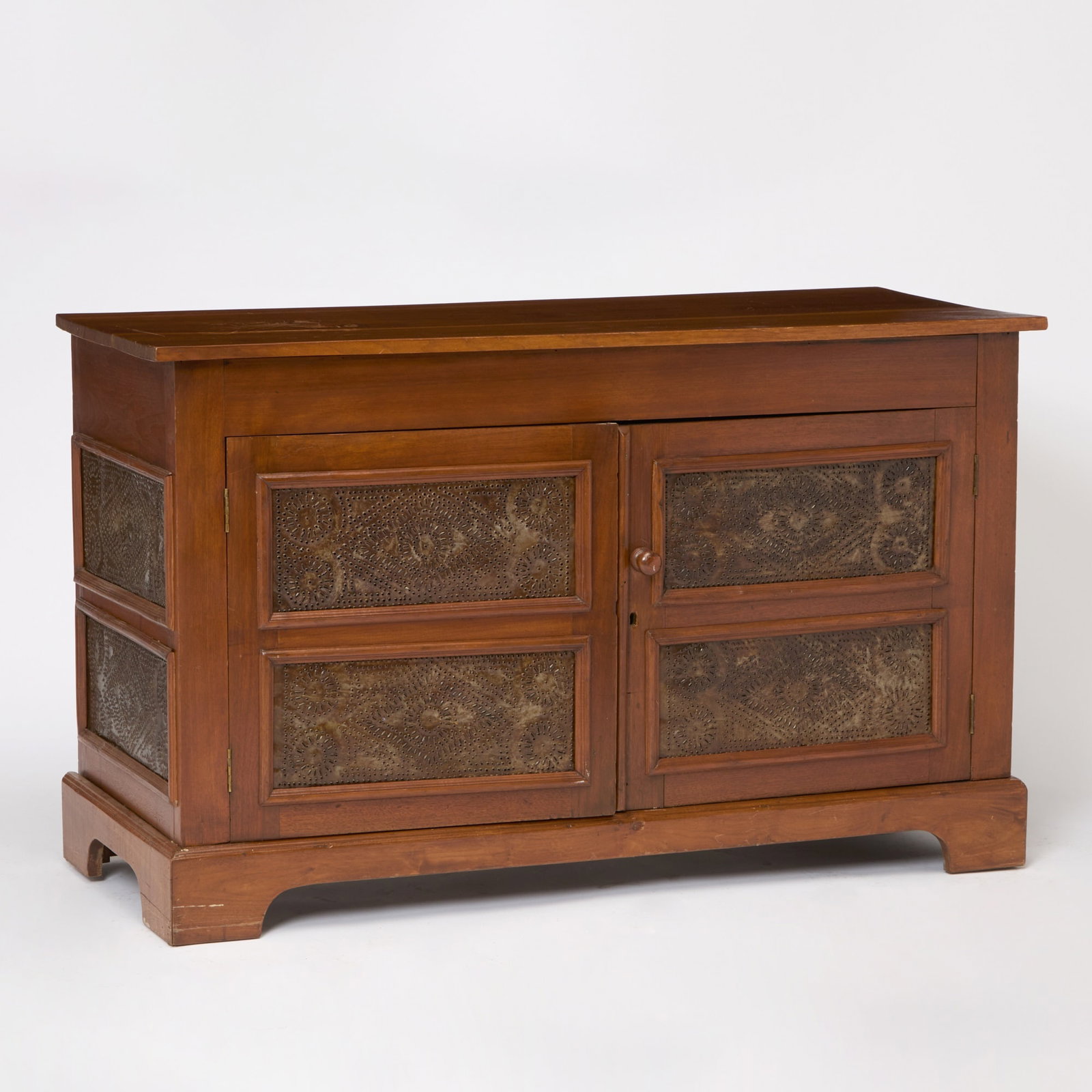 Walnut and Pine Cabinet with Pierced Tin Inset Doors: 19th Century and later Height 35 inches, width 57 inches, depth 22 1/2 inches. damaged finish on top