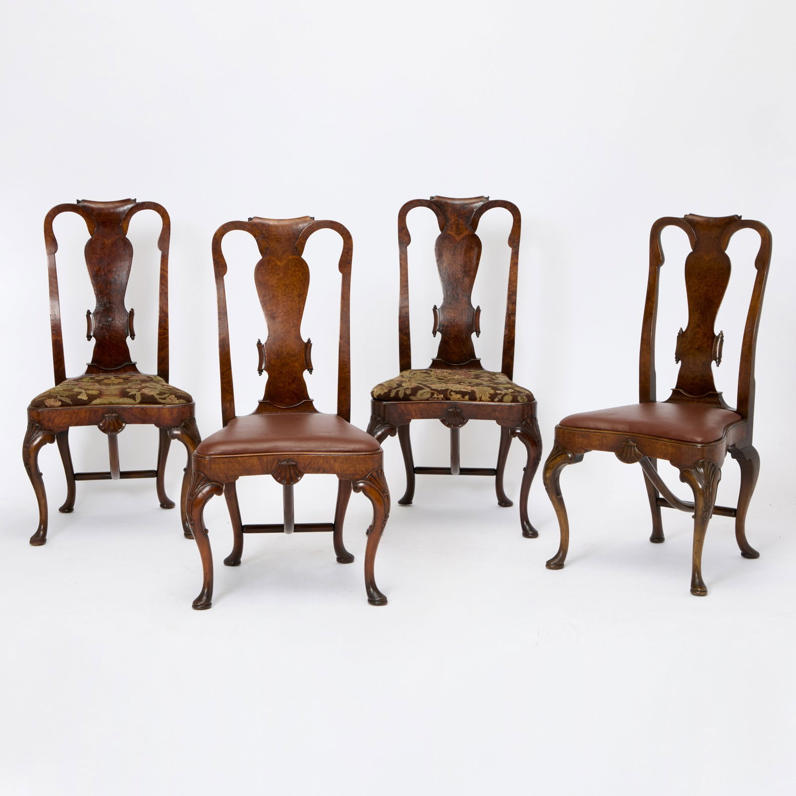 Set of Four George I Style Walnut Side Chairs: Early to mid-20th century Burl walnut veneered backs and seat rails, two chairs with tapestry upholstery and two with brown leather. Height 41 inches, width 21 inches, depth 18 inches.