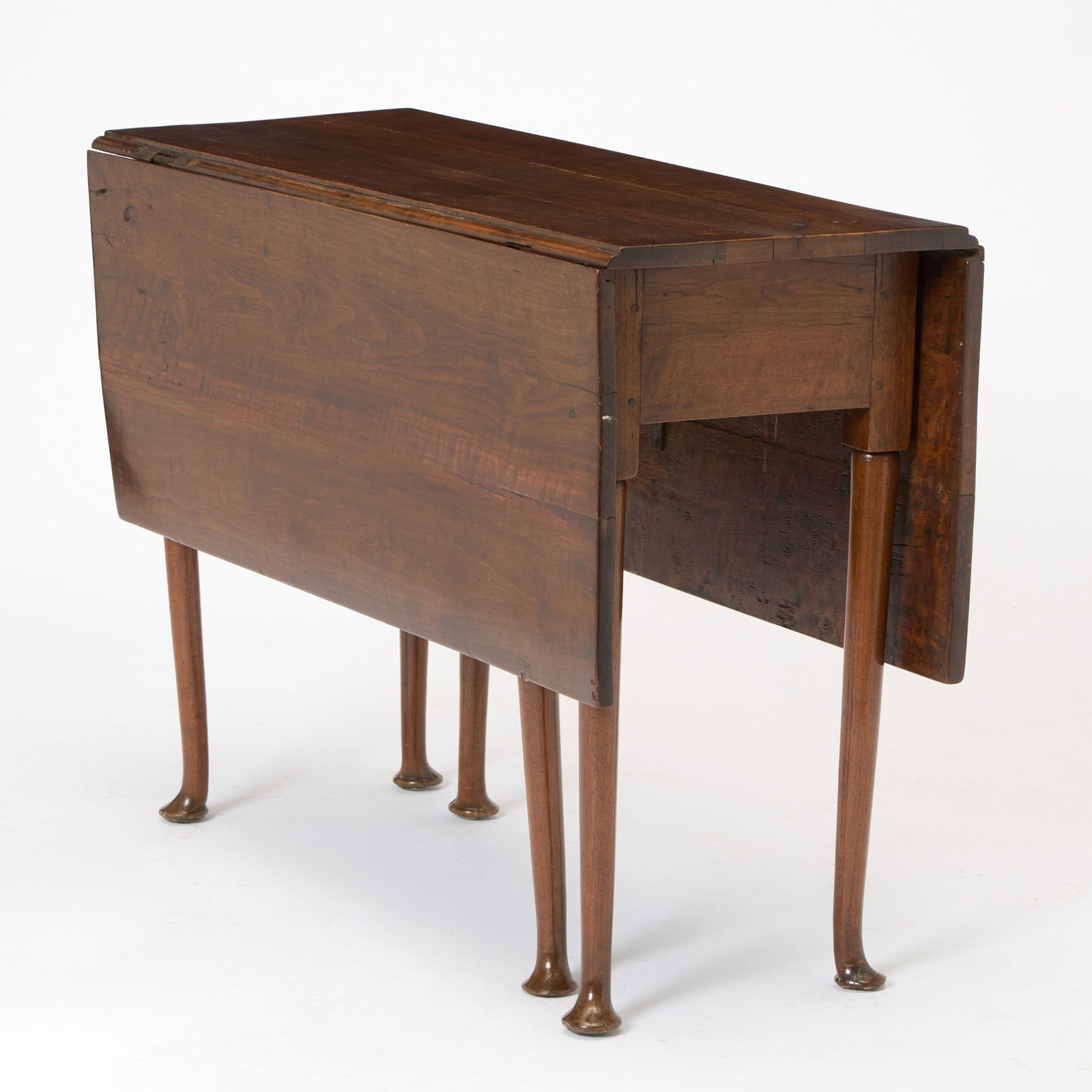 Queen Anne Walnut Six-Legged Drop-Leaf Dining Table: Probably Pennsylvania, 1740-60 The rectangular drop leaves above a straight apron and tapering legs ending in pad feet. Height 29 inches, width 42 inches,closed depth 16 inches, open depth 46 inches.
