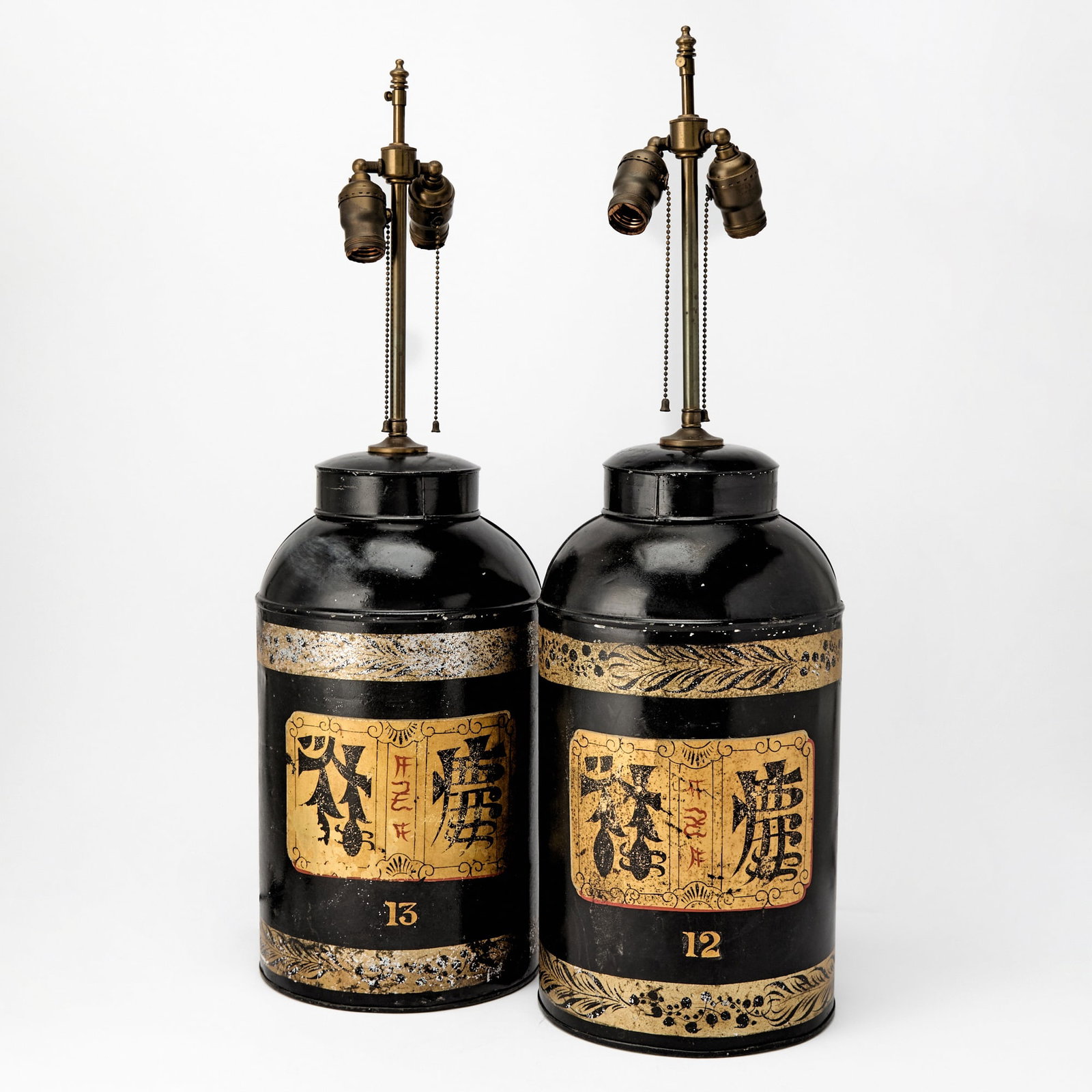 Pair of Black Painted Tole Cannister Lamps: Height 17 inches.