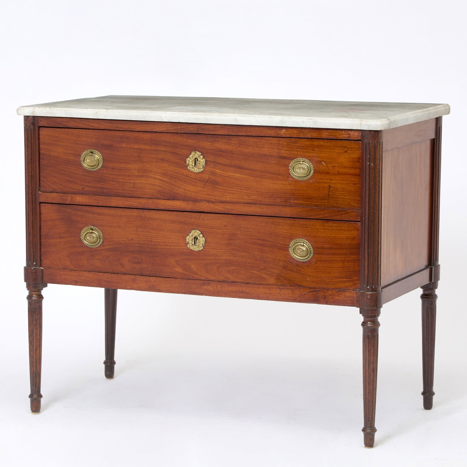 Continental Neoclassical Marble Top Mahogany Commode: Late 18th century The rectangular marble top with rounded outset corners, above two long drawers flanked by fluted stiles, raised on fluted tapering legs. Height 35 inches, width 44 inches, depth 22 i