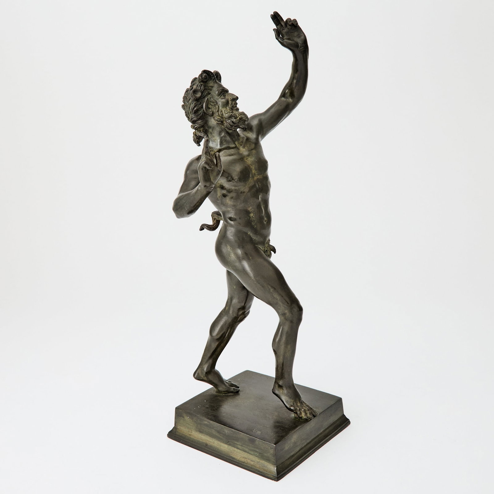 Italian Patinated Bronze Figure of the Dancing Faun: After the antique, early 20th century The standing figure raised on a square plinth; brown patina. Height 16 3/4 inches.