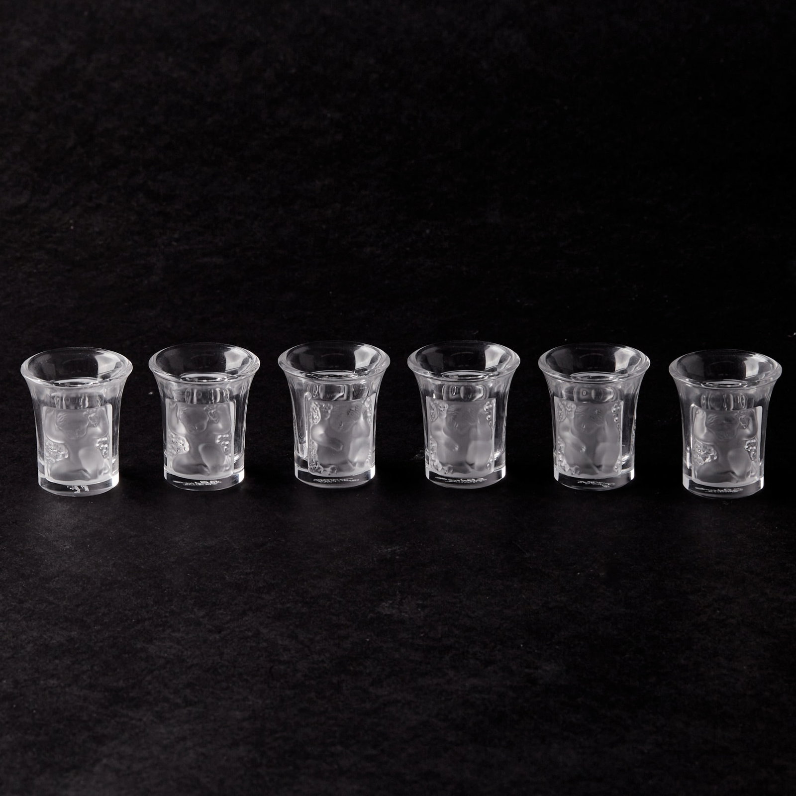 Group of Six Lalique "Enfants" Molded Glass Shot Glasses: Height 1 3/4 inches. generally good condition