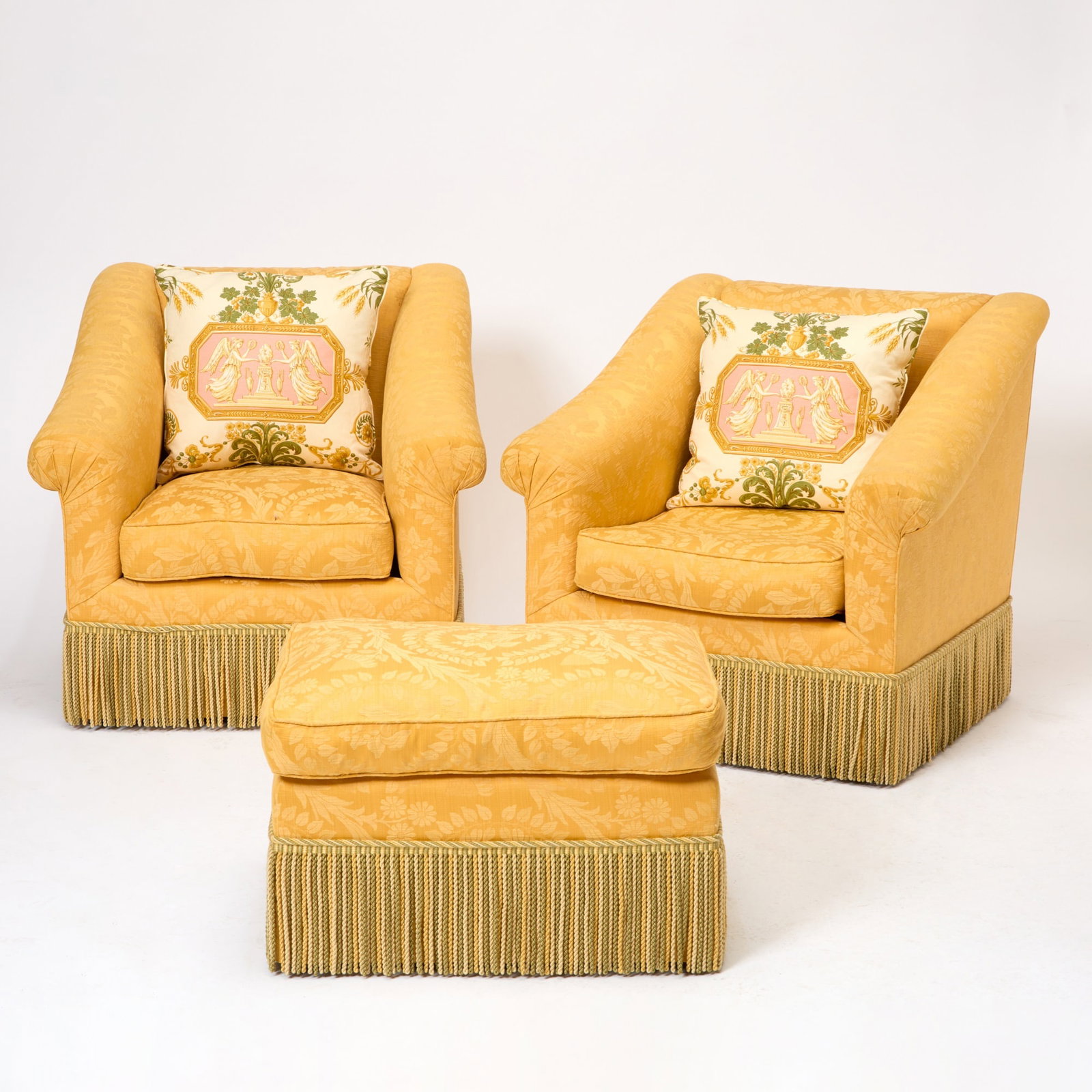 Pair of Damask Upholstered Lounge Chairs: Together with a matching ottoman, and six floral pillows. Pair of chairs: Height 34 inches, width 34 inches, depth 34 inches. Ottoman: Height 17 inches, width 27 inches, depth 21 inches.