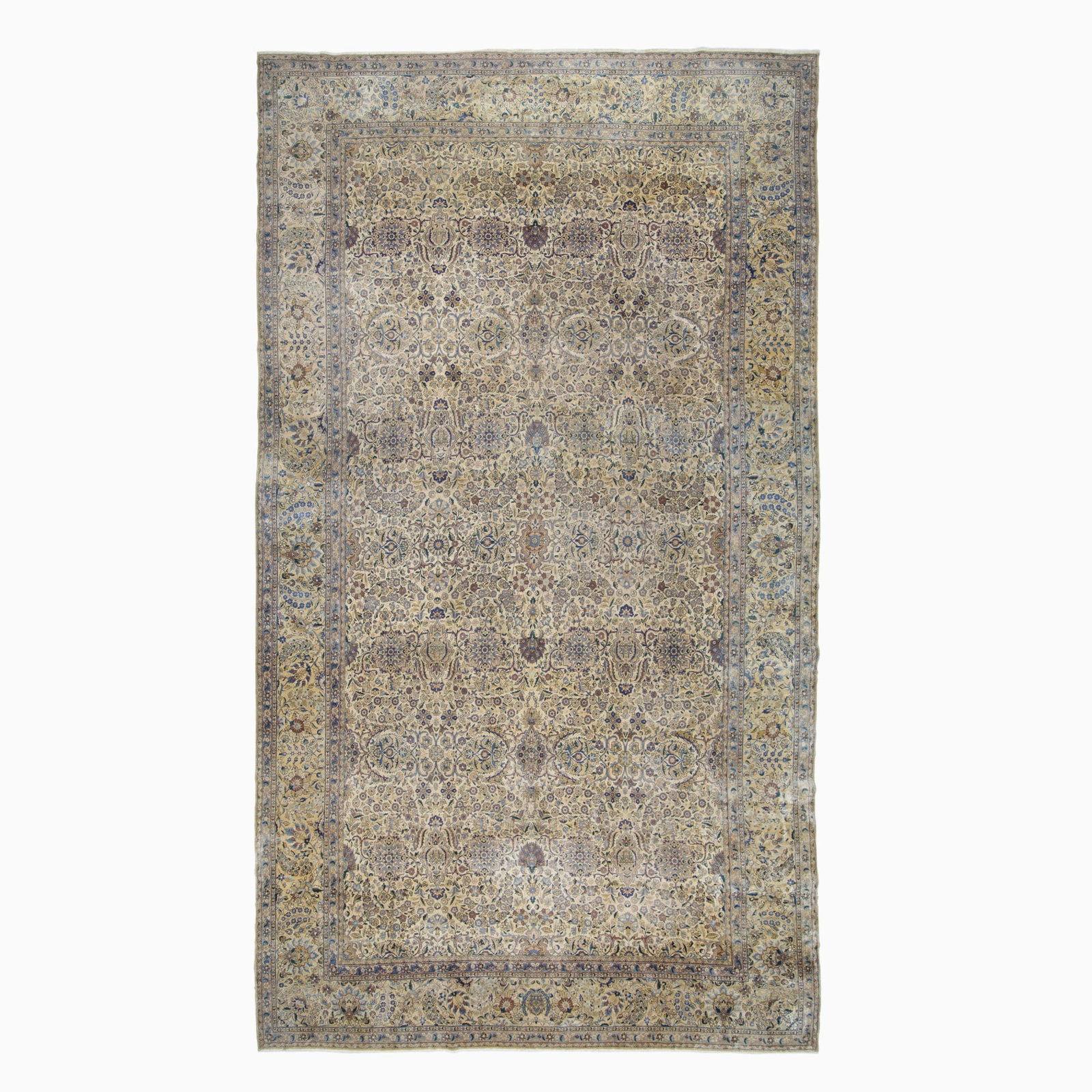 Kerman Carpet: Southeast Persia, 2nd 1/4 20th Century The overall pattern of intricate polychrome floral vinery on the buff field is within a palmette and vine border. Manufactured by Dilmaghani with crown