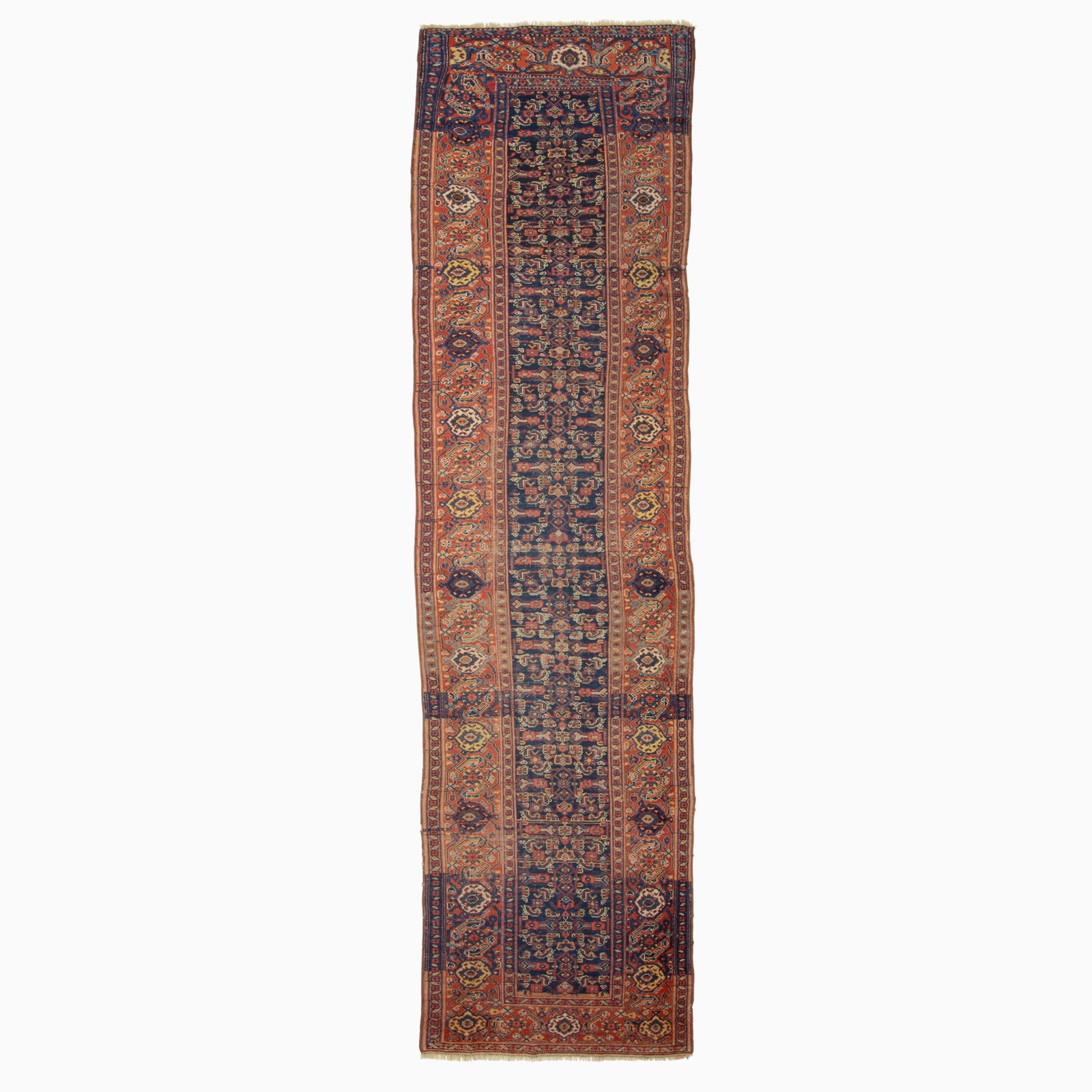Kurdish Runner: West Persia, early 20th century The indigo field with a polychrome Herati pattern overall is within a madder palmette and vine border. (13' 4" x 3' 8") Areas of wear, re-wrapped selvedges, restored