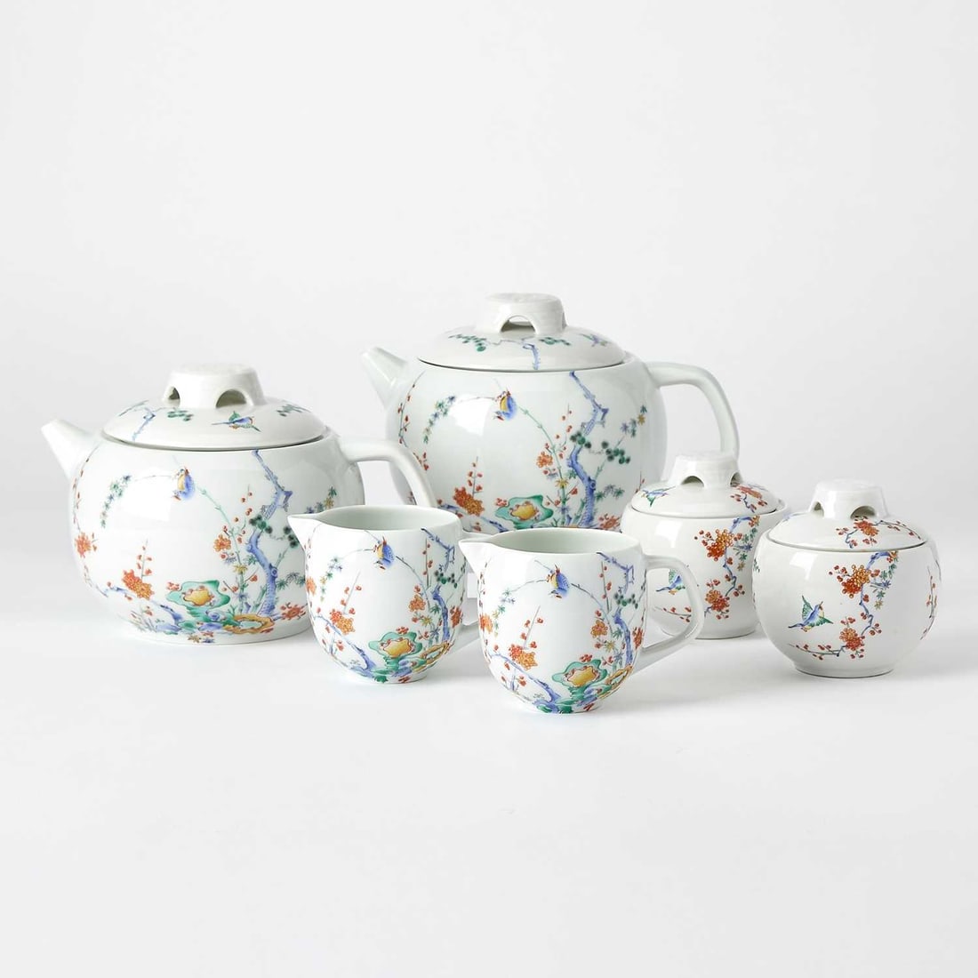 Limoges Porcelain Partial Tea Service: In the Kakiemon palette, comprising two teapots, with short spouts, length over handles 8 1/2 inches; two cream jugs; and two covered sugar bowls. (6)
