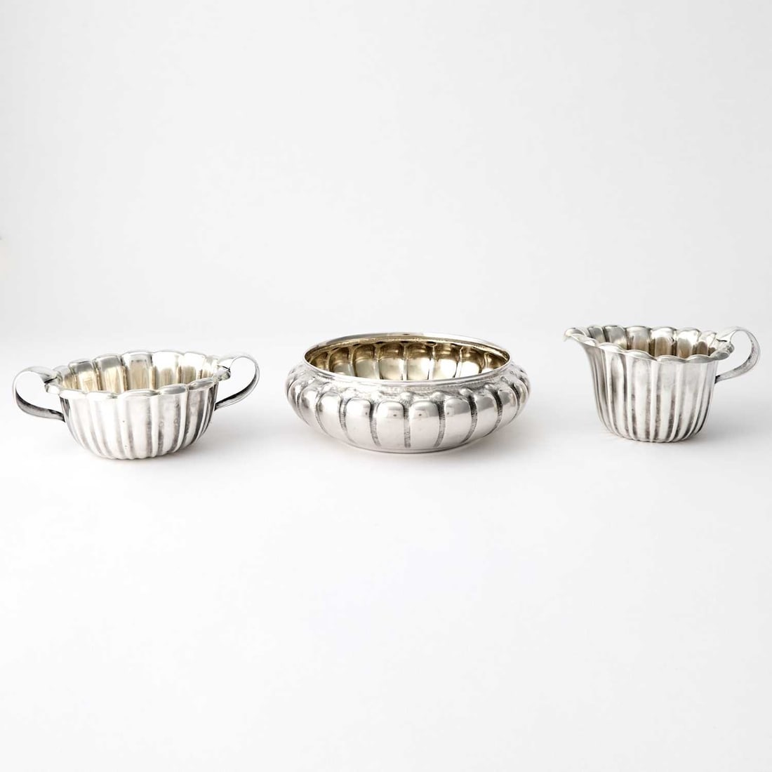 Whiting Sterling Silver Cream Jug, Sugar Bowl and Bowl: Early 20th century Each with a lobed body. Diameter of largest 6 3/4 inches, total approximately 17 ounces. Generally good condition overall with small dents from normal use