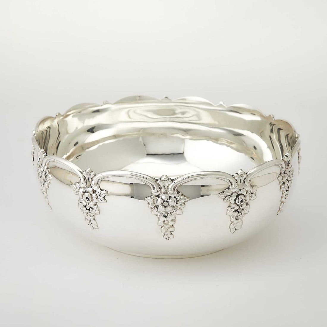 Tiffany & Co. Sterling Silver Fruit Bowl: 1902-1907 Circular, the arched rim with floral pendants. Height 3 1/8 inches, diameter 8 1/4 inches, approximately 19 ounces.