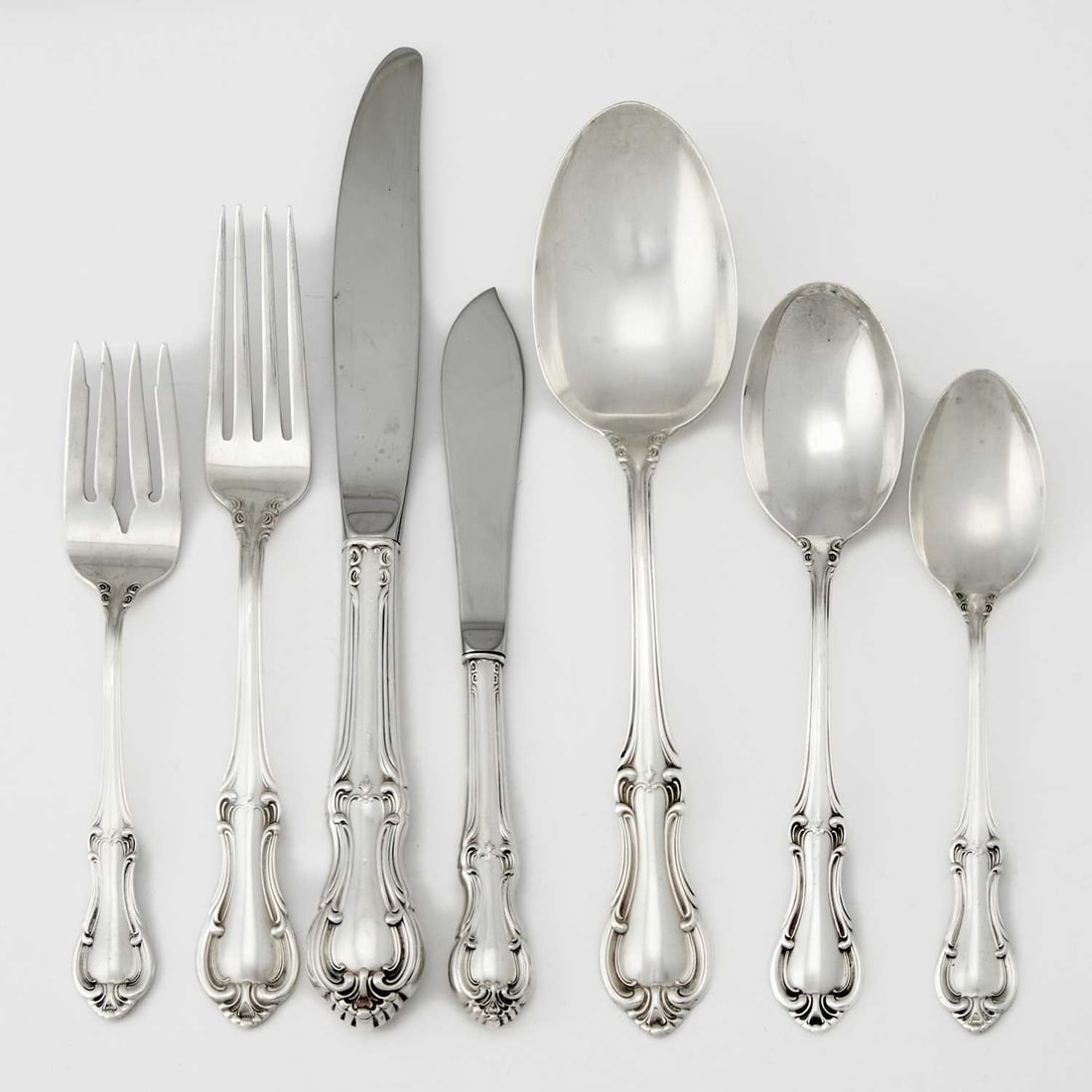 International Sterling Silver "Joan of Arc" Pattern Part Flatware Service: Mid 20th century Comprising: Ten dinner forks Nine salad forks Ten dinner knives Eight dessert spoons Ten teaspoons Serving spoon Pierced serving spoon Serving fork Cake server Master butter