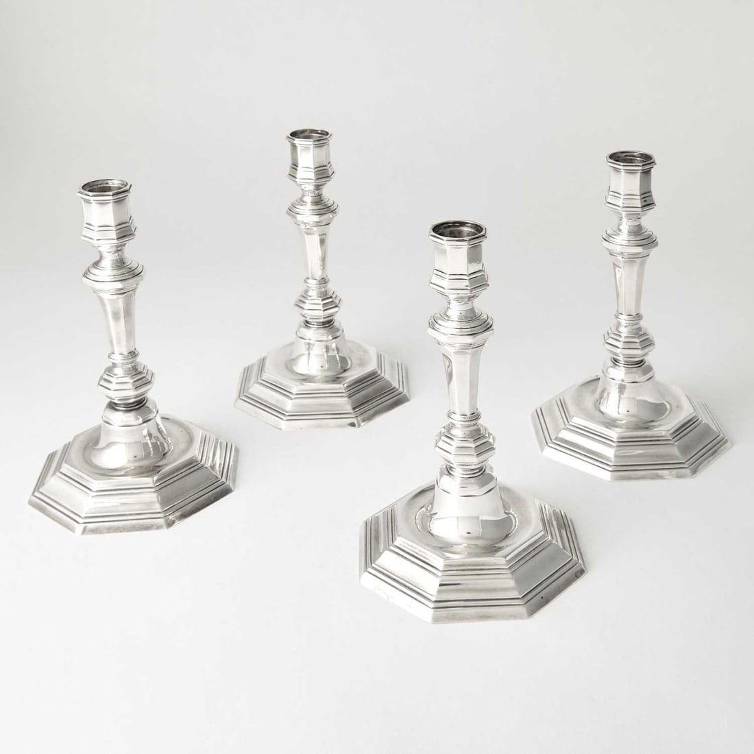 Set of Four Christofle Silver Plated Candlesticks: 20th Century Each faceted knopped stem on an octagonal base. Height 8 5/8 inches.
