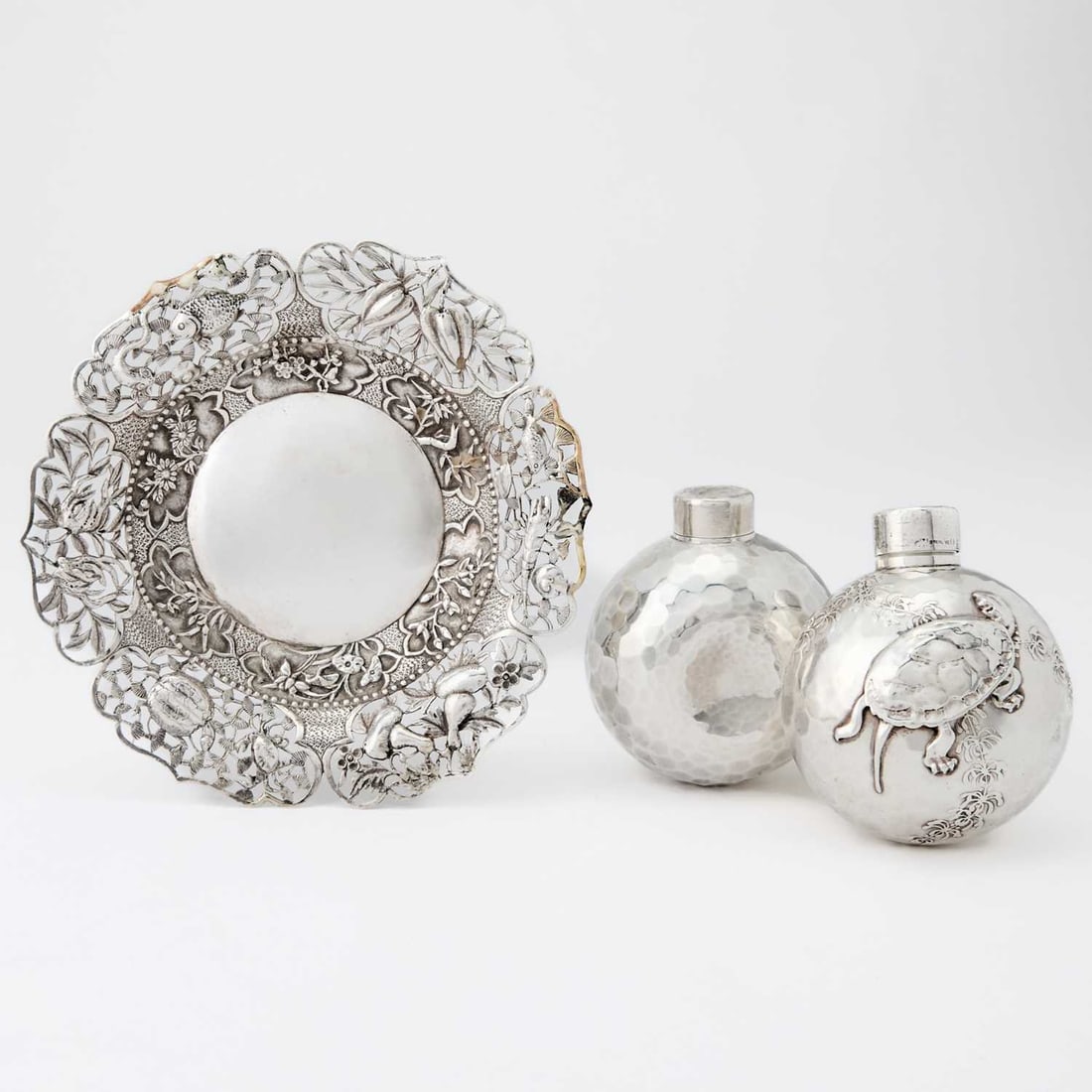Pair of Whiting Aesthetic Movement Sterling Silver Ball-Form Scent Flasks: Late 19th century Each with hammered surface, one with an applied figure of a turtle. Heights 3 inches; Together with a Chinese Export Silver Dish, retailed by Pau Kuang, Hong Kong. Diameter 6 i