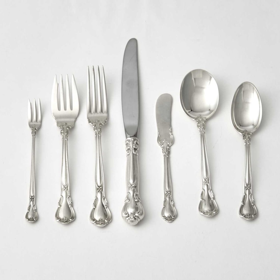 Gorham Sterling Silver "Chantilly" Pattern Flatware Service: 20th Century Comprising: Twenty-four lunch forks Twenty-four salad forks Eleven cocktail forks Twelve lunch knives Twelve butter knives Twelve round soup spoons Twenty-eight teaspoons Total appro
